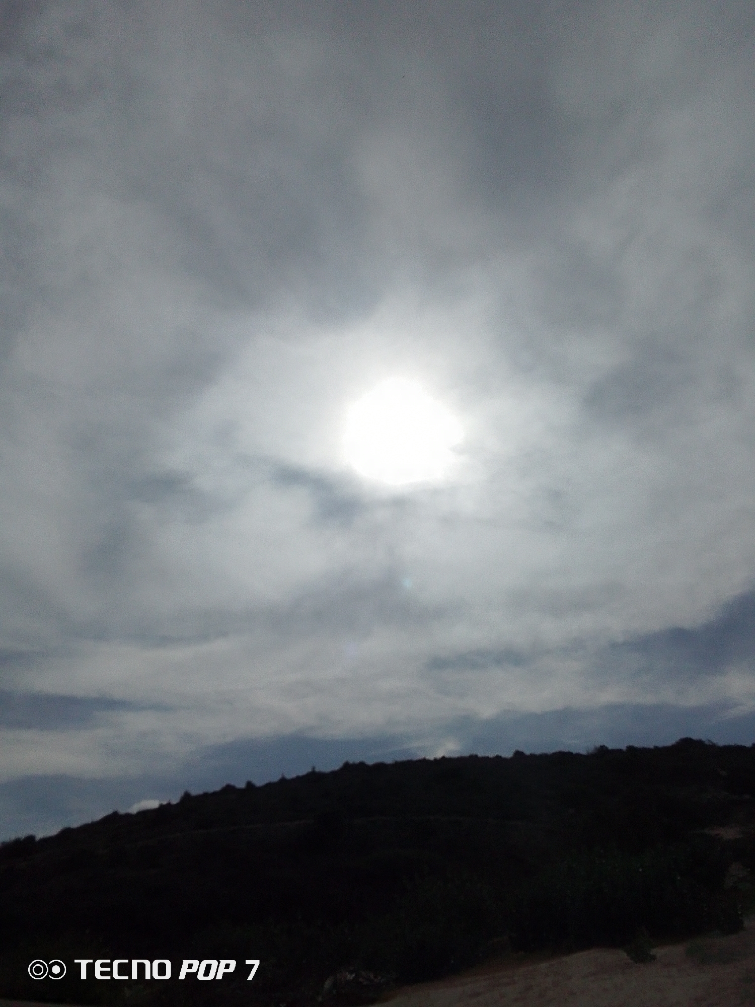 Sunlight breaks through overcast sky over Venezuelan landscape