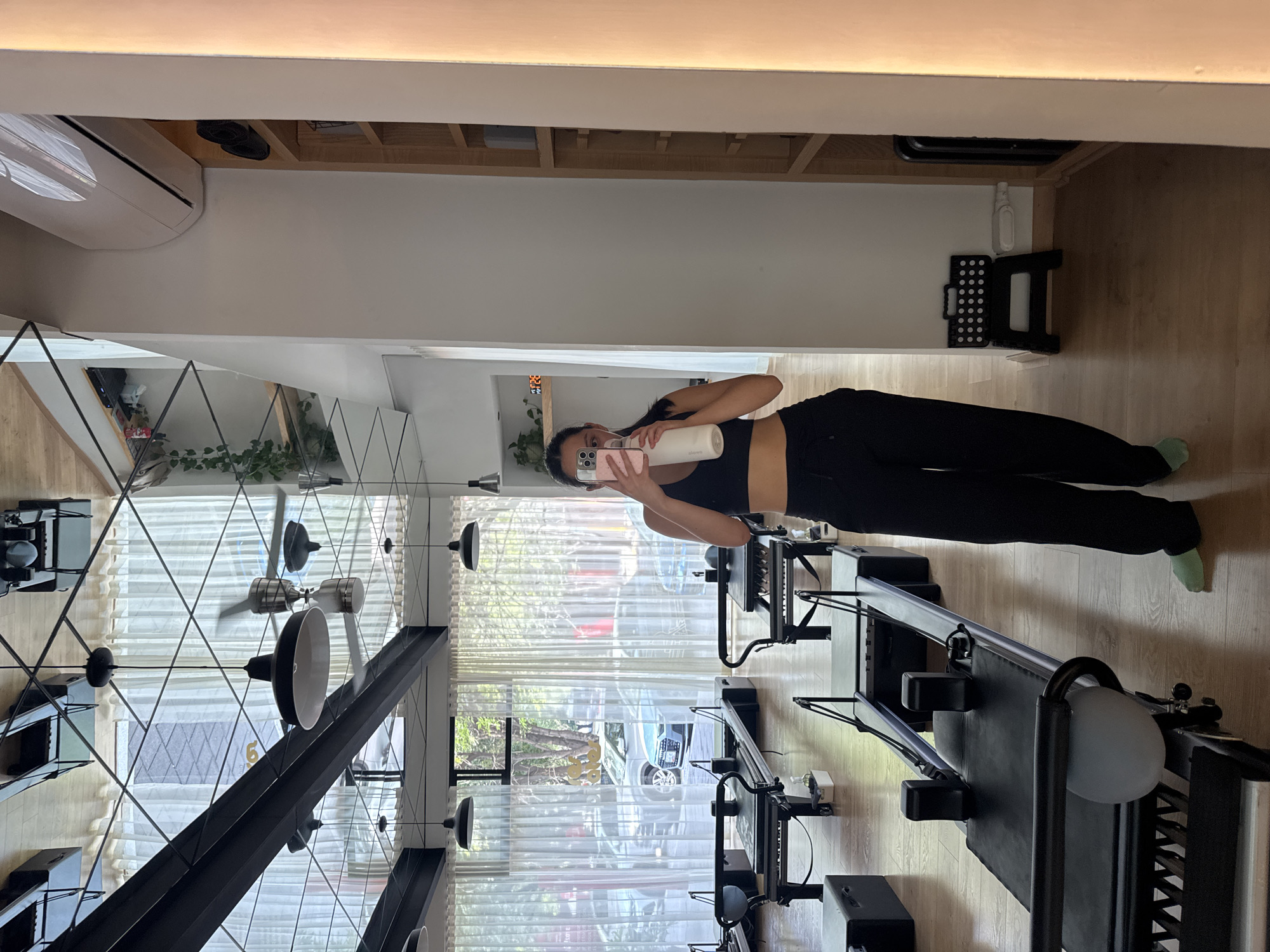Woman takes selfie at Tres Pilates Studio in Puebla
