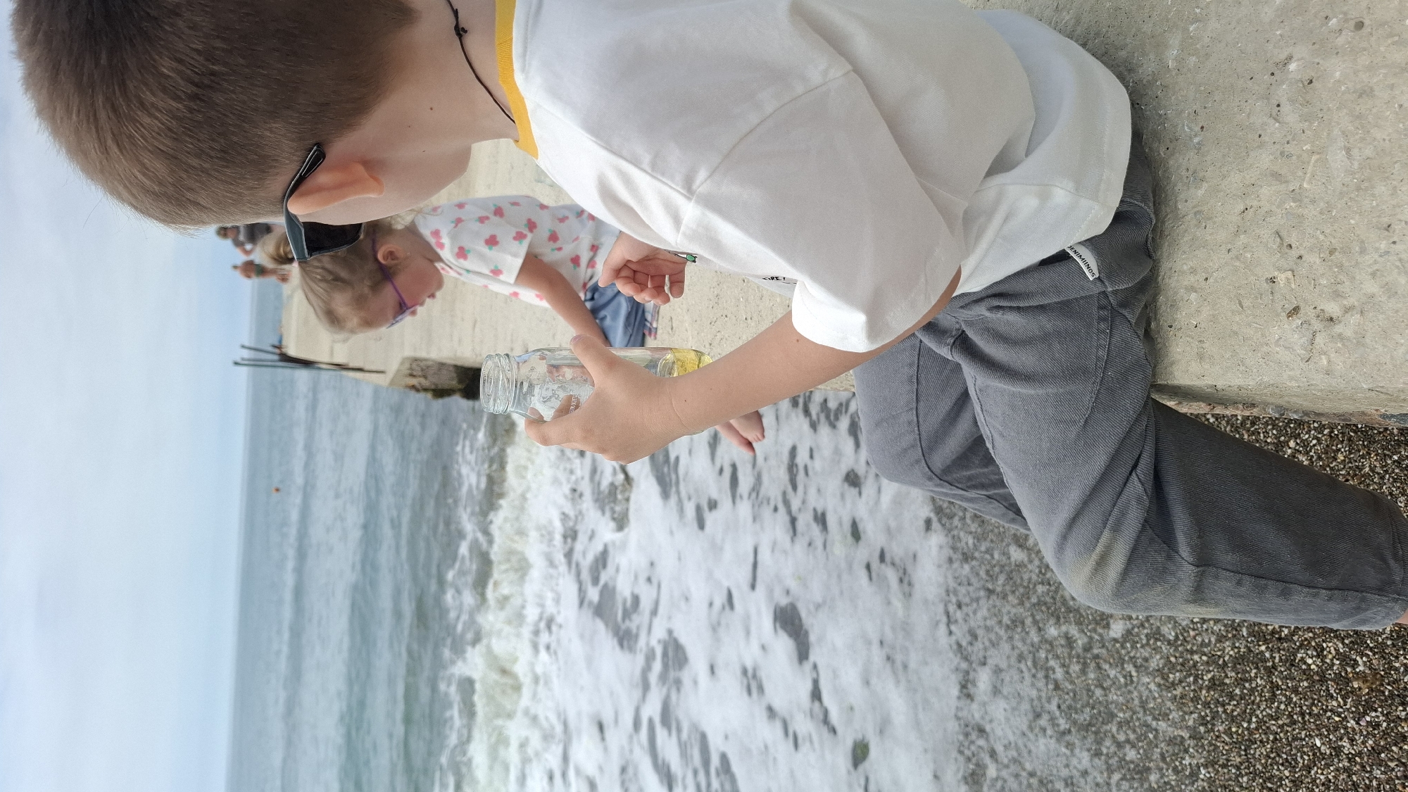 Family beach outing documented at coastal pier location