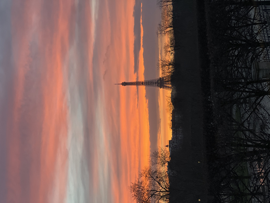 Dramatic sunset illuminates Paris skyline with Eiffel Tower silhouetted
