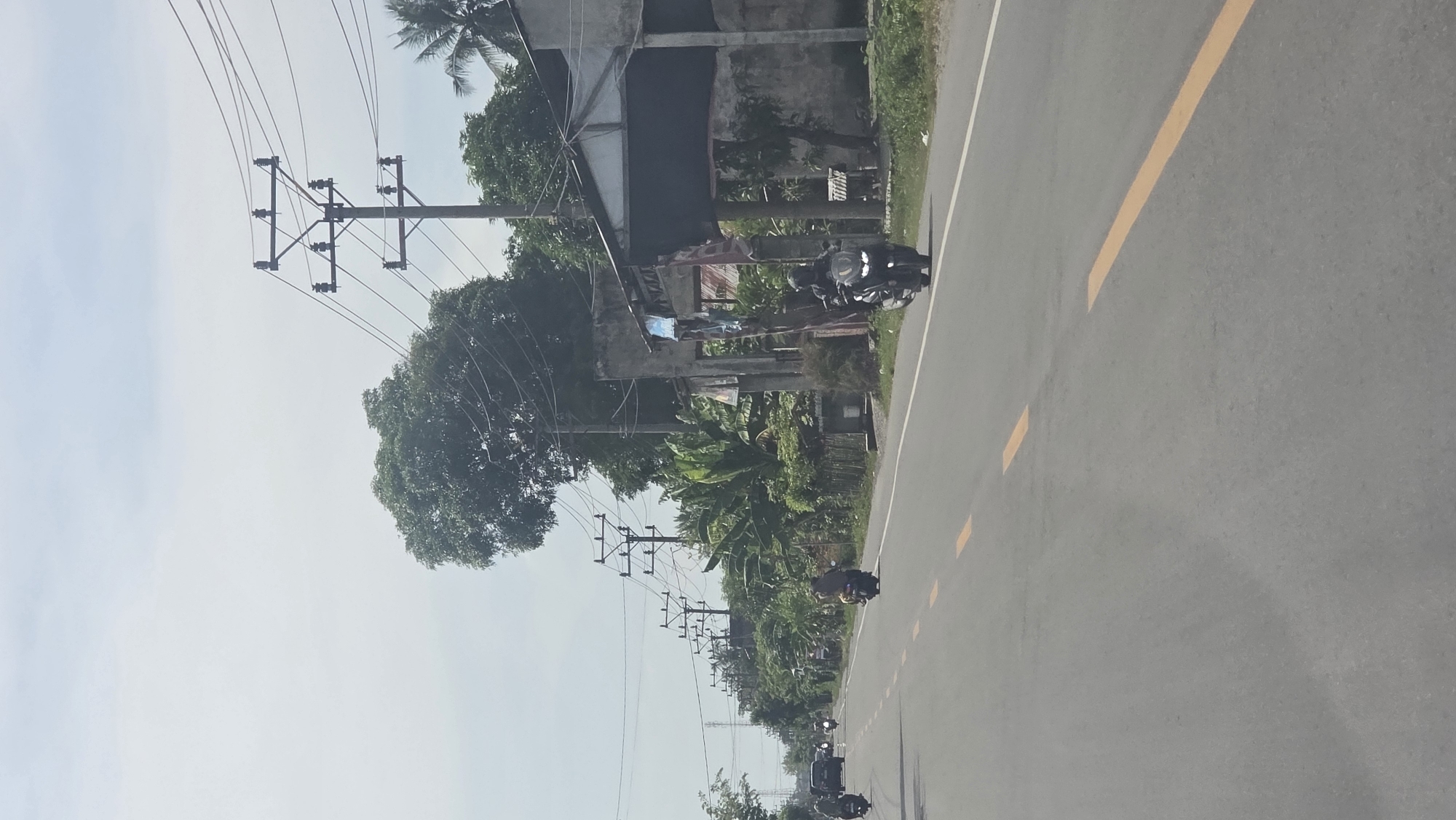 Morning traffic flows on main road in Teungoh Baro