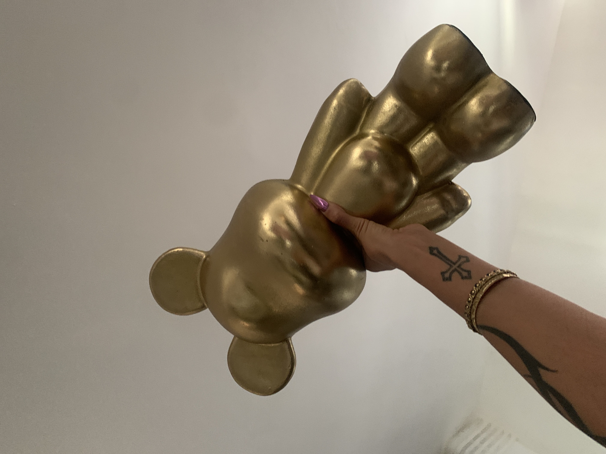 Person photographs objects including sculpture, plush toy in London