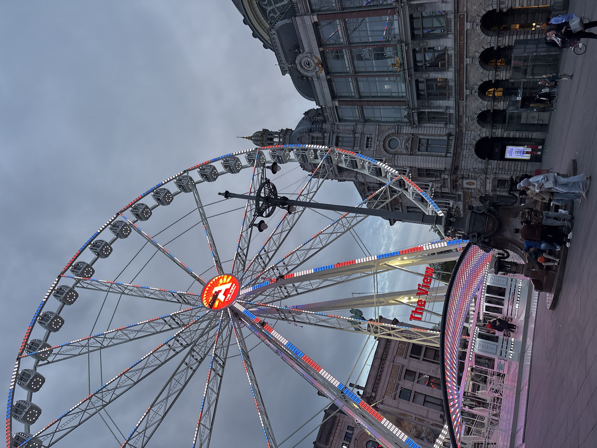 Illuminated Ferris wheel draws attention in historic Antwerp evening