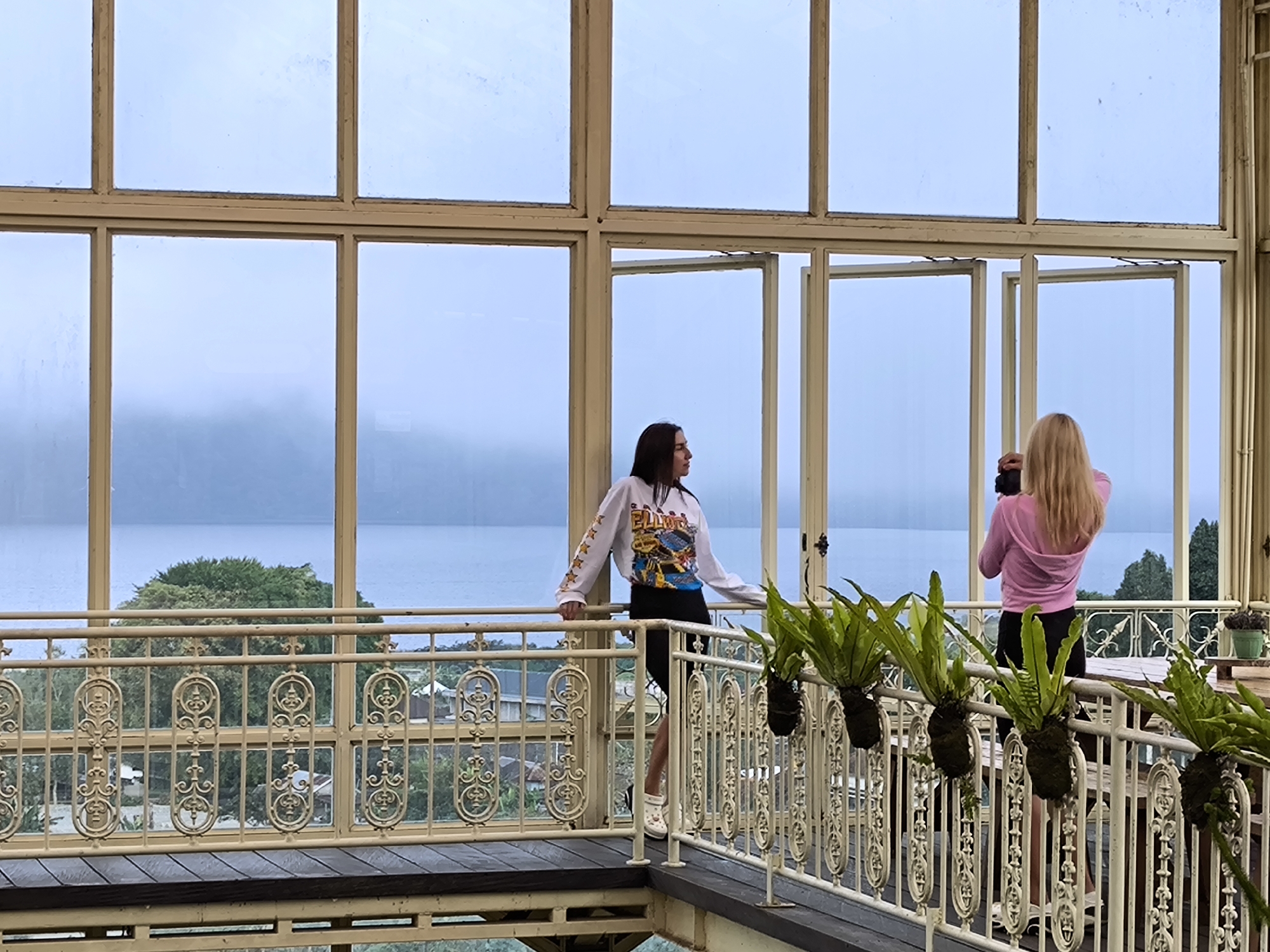 Two women tour greenhouse facility in Candikuning, Indonesia