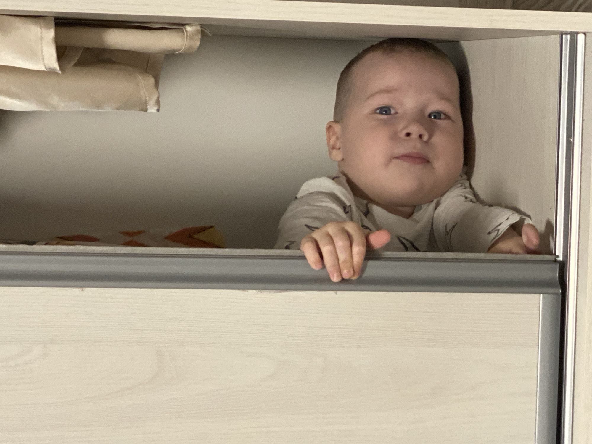Child plays hide-and-seek in furniture at Sochi home