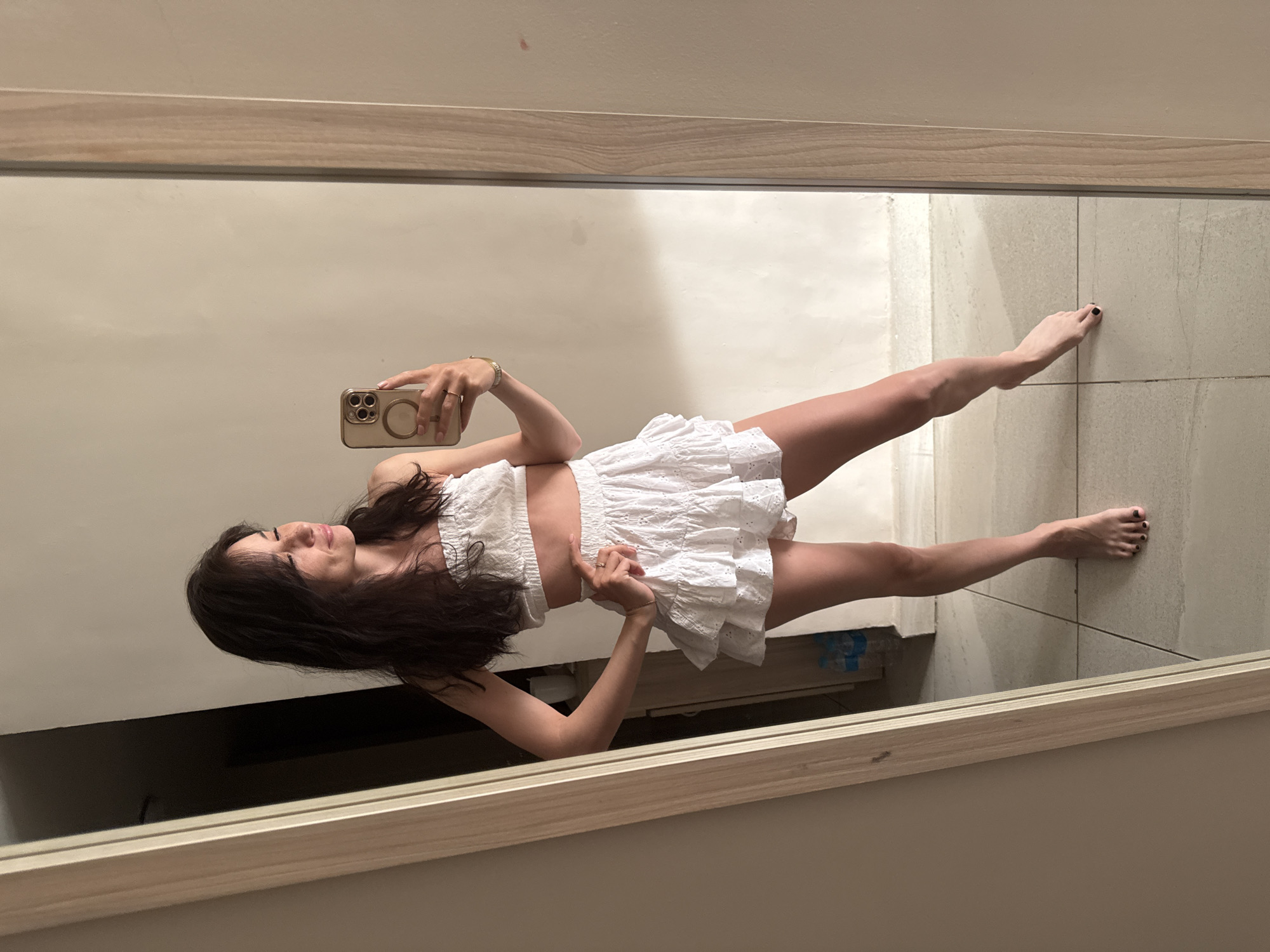 Woman takes mirror selfie in white outfit, Safaga Egypt