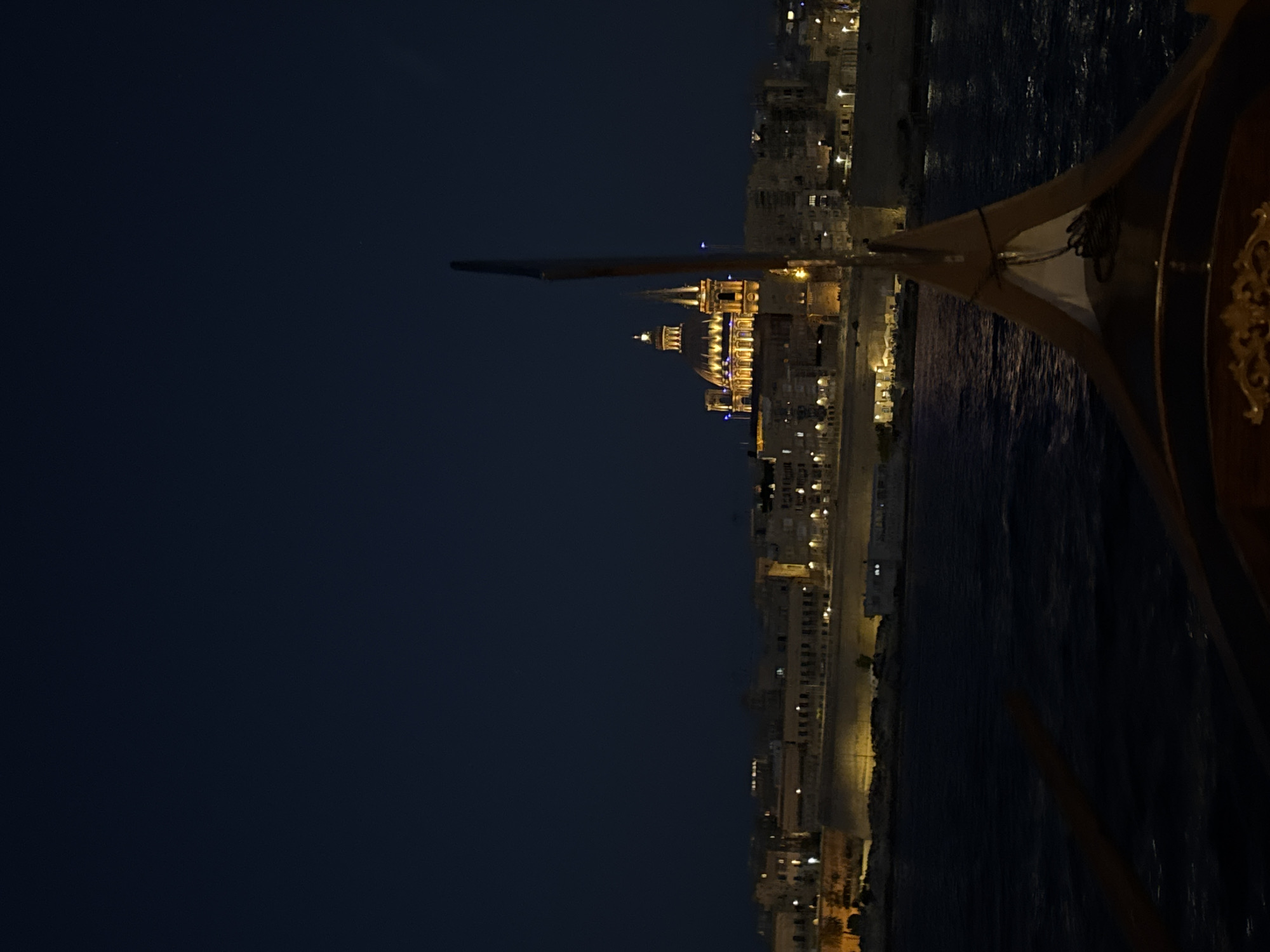 Malta's harbour coastline glows at night from the water