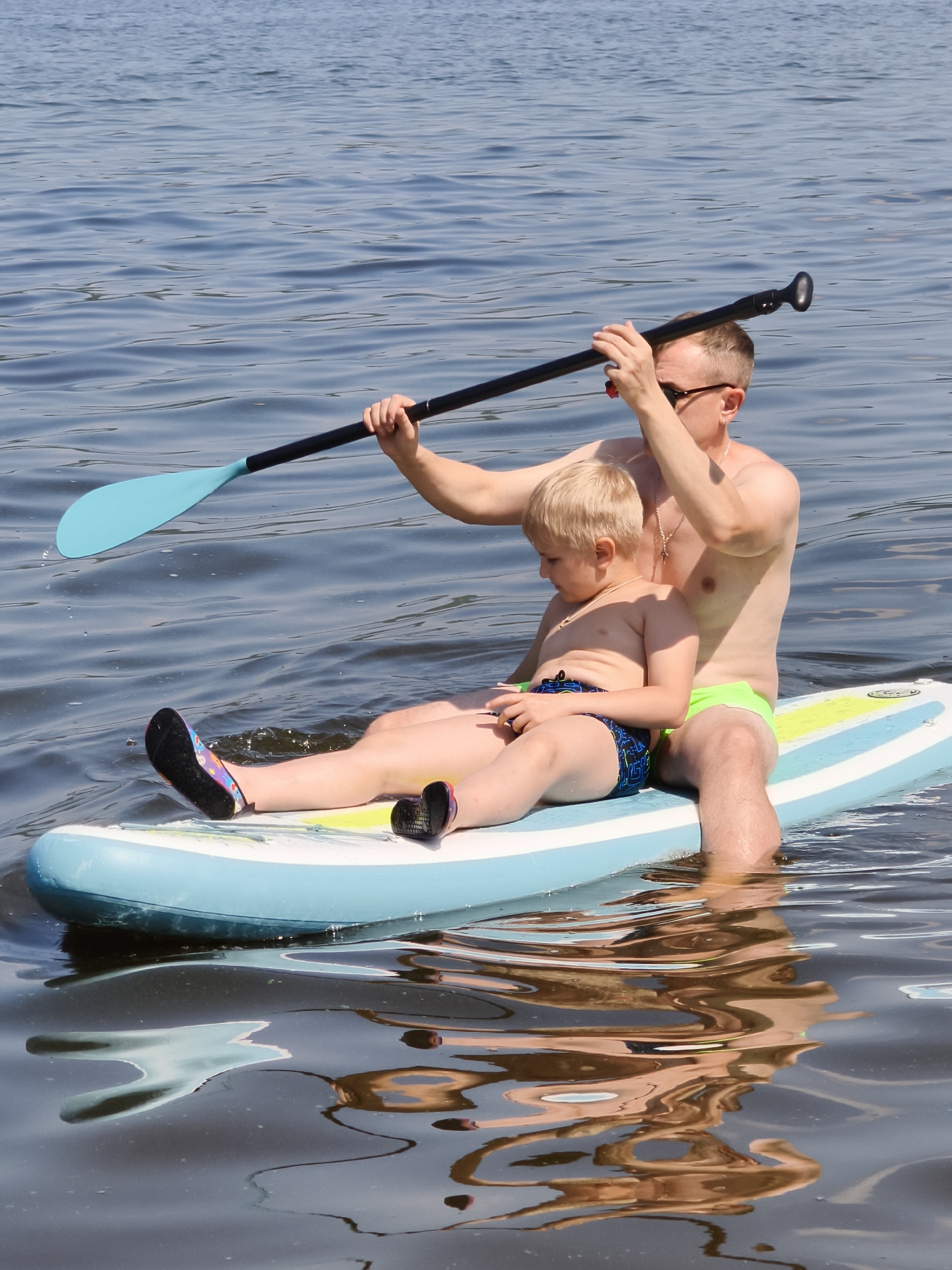 Paddleboarding on calm water in Chaikovsky on a clear summer day