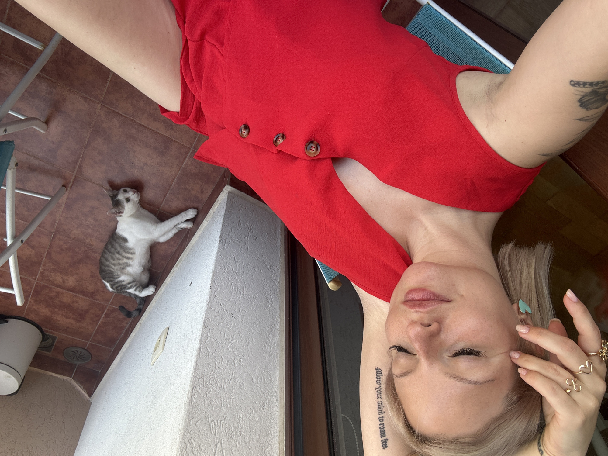 Slow afternoon on a Budva patio with a cat and red romper