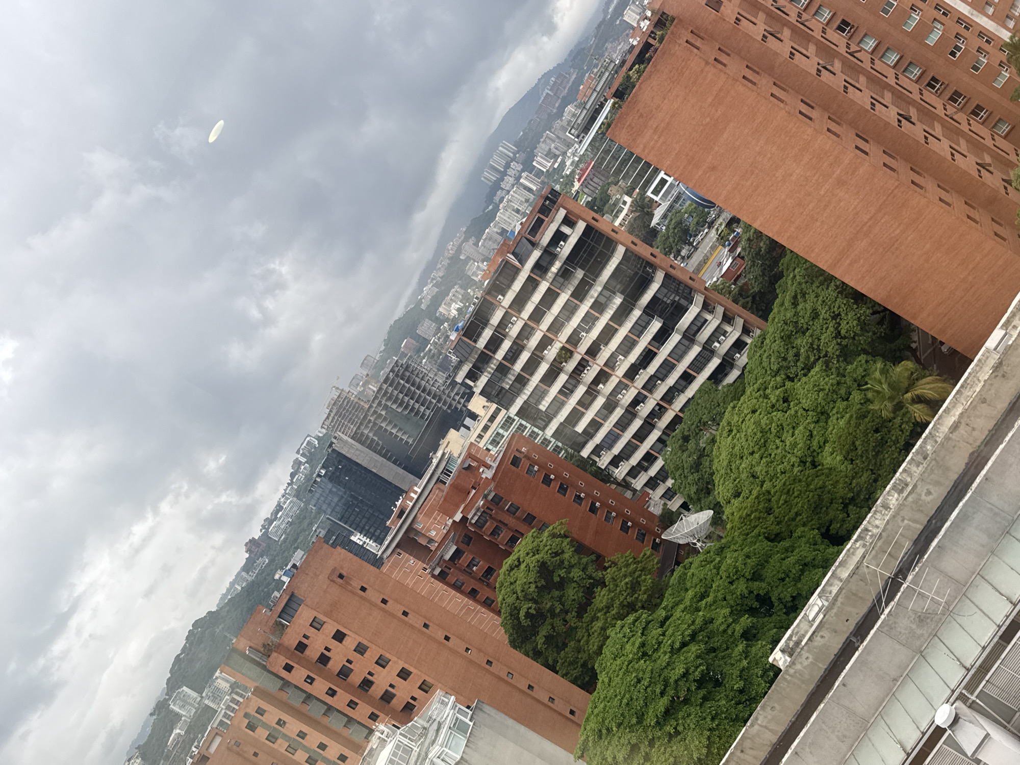 Aerial view captures cloudy day over dense Caracas cityscape