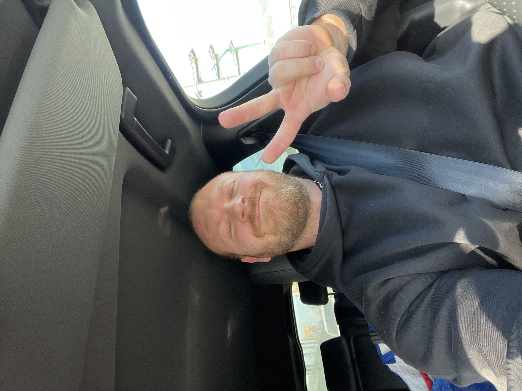 Driver smiles for camera in Chaikovsky vehicle