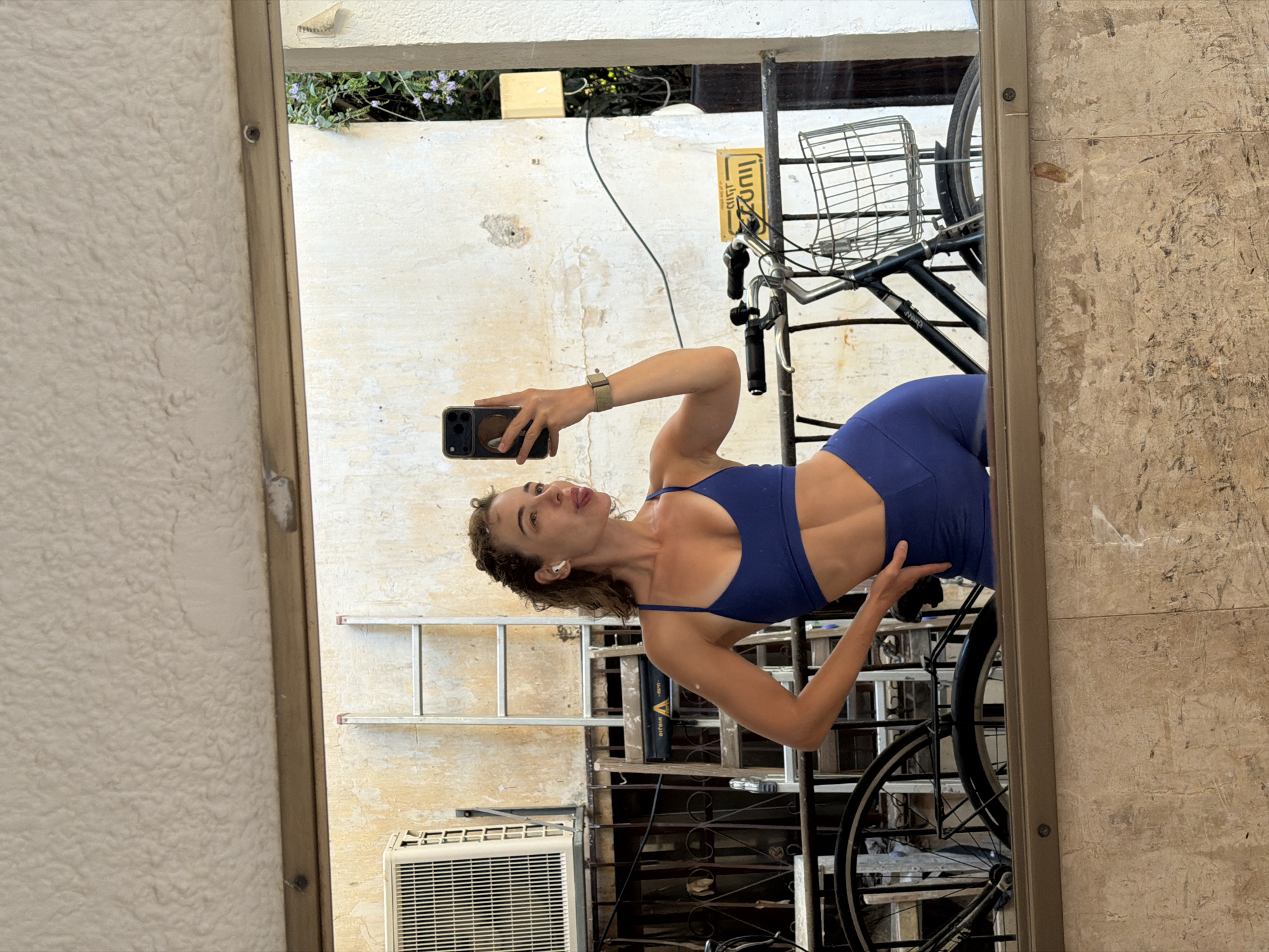 Outdoor mirror selfie in a blue athletic set, Tel Aviv