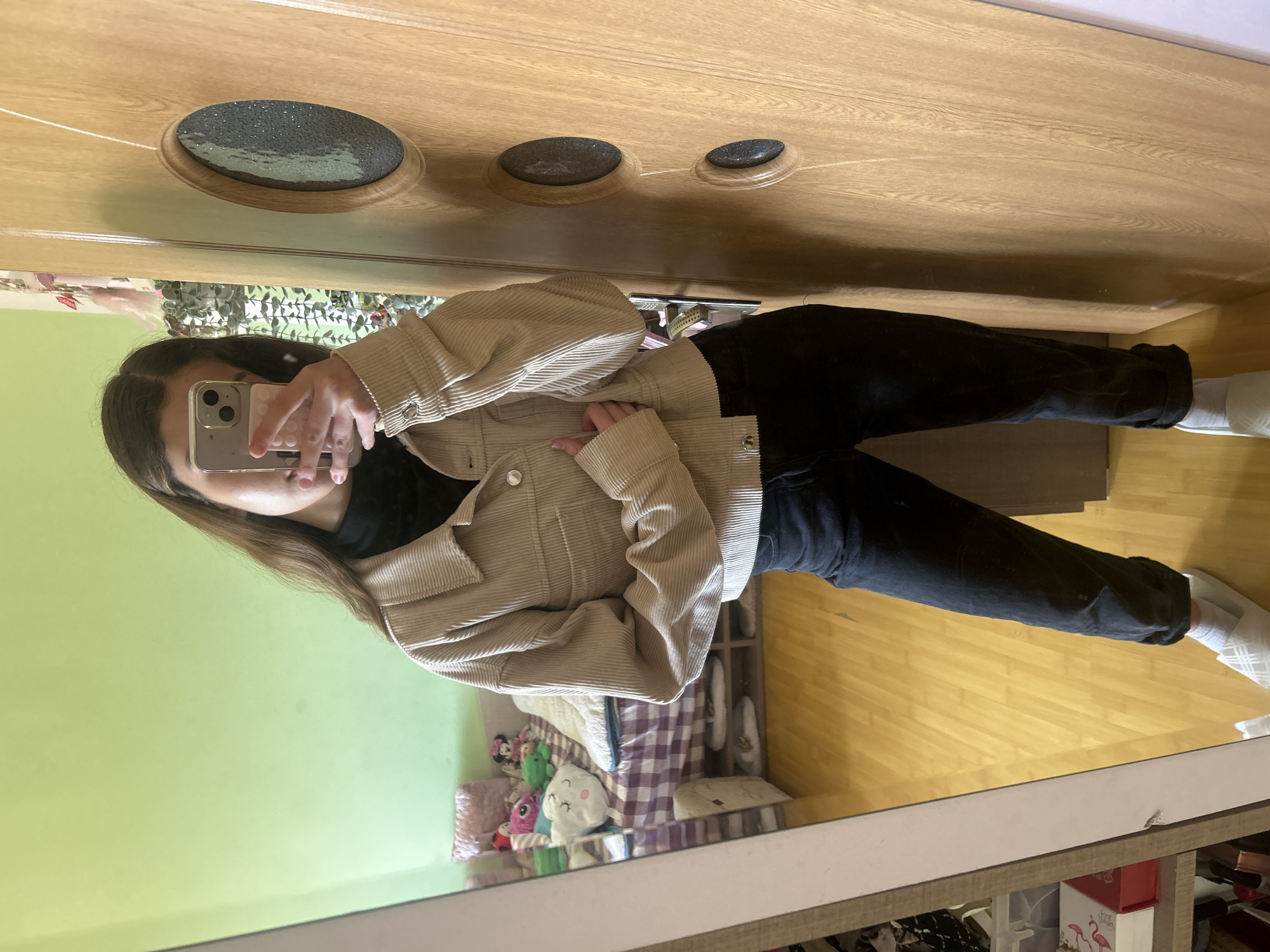 Woman takes mirror selfie in bedroom in Ruse, Bulgaria