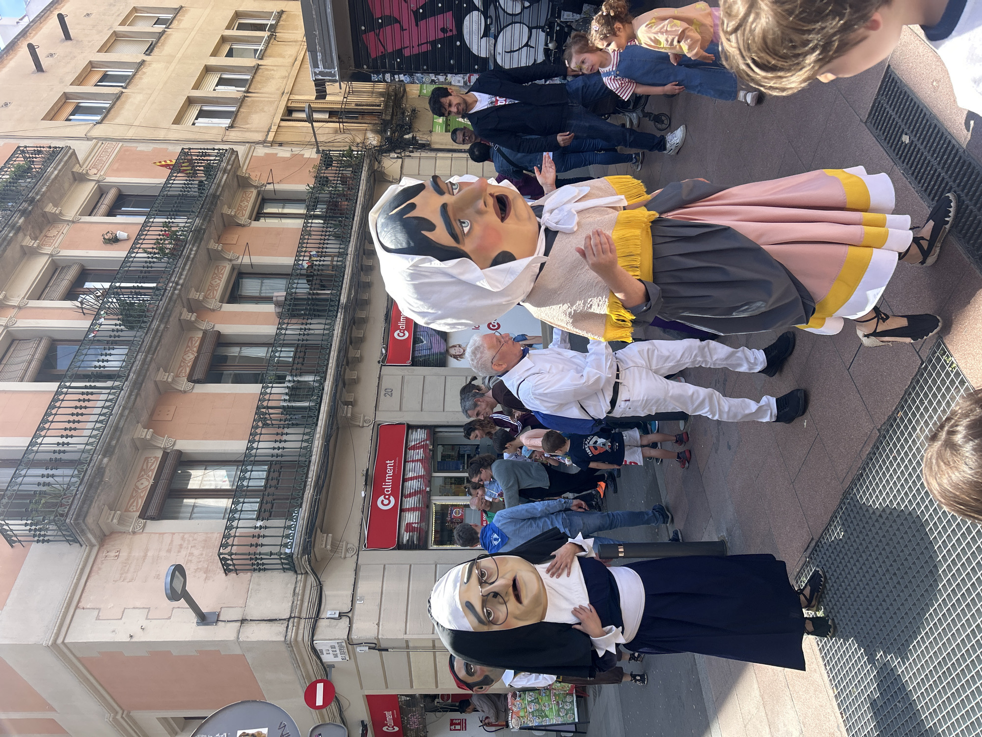 Traditional parade with giant figures marches through Barcelona streets