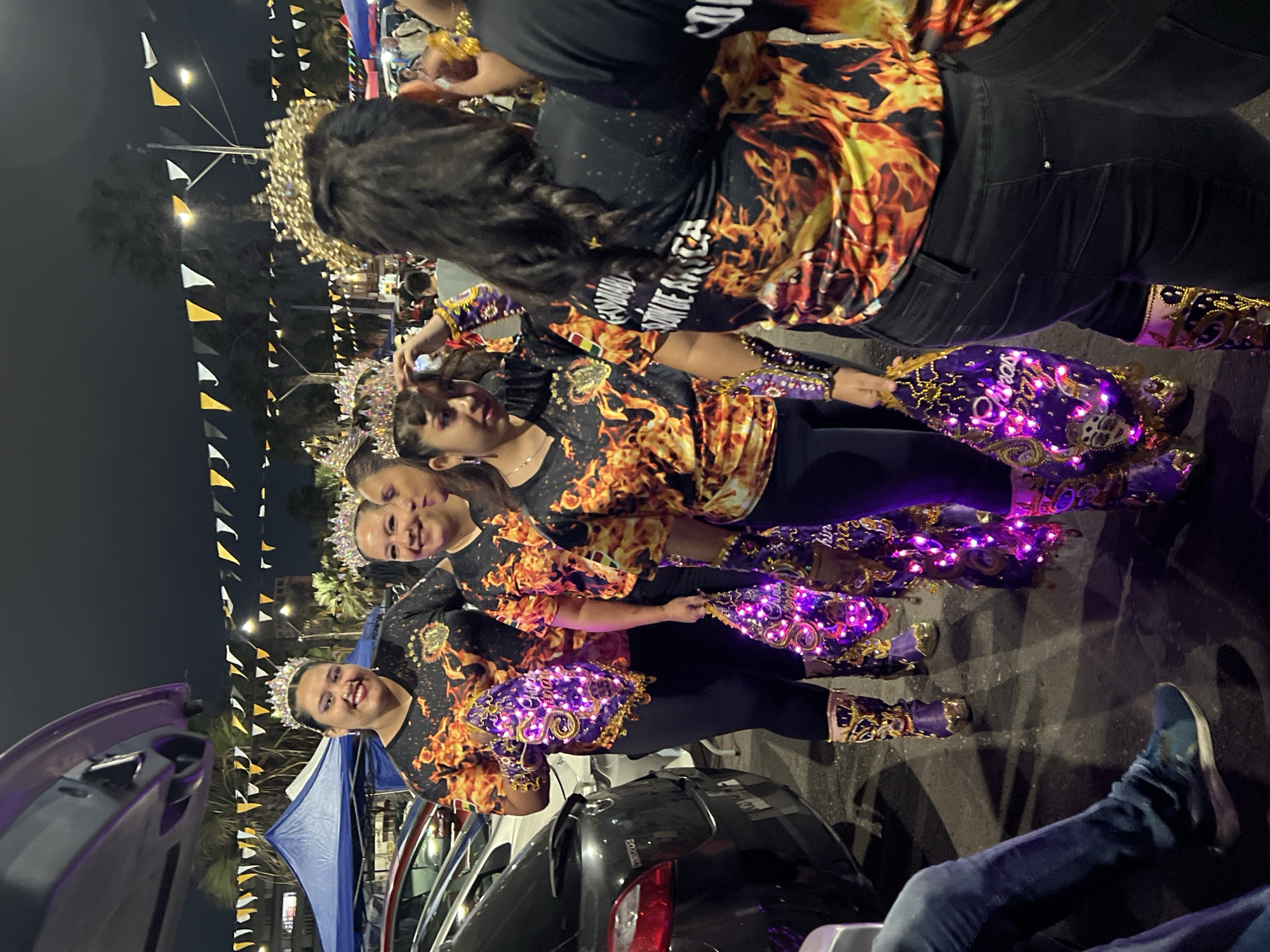 Nighttime street festival with costumed dancers in Arica, Chile