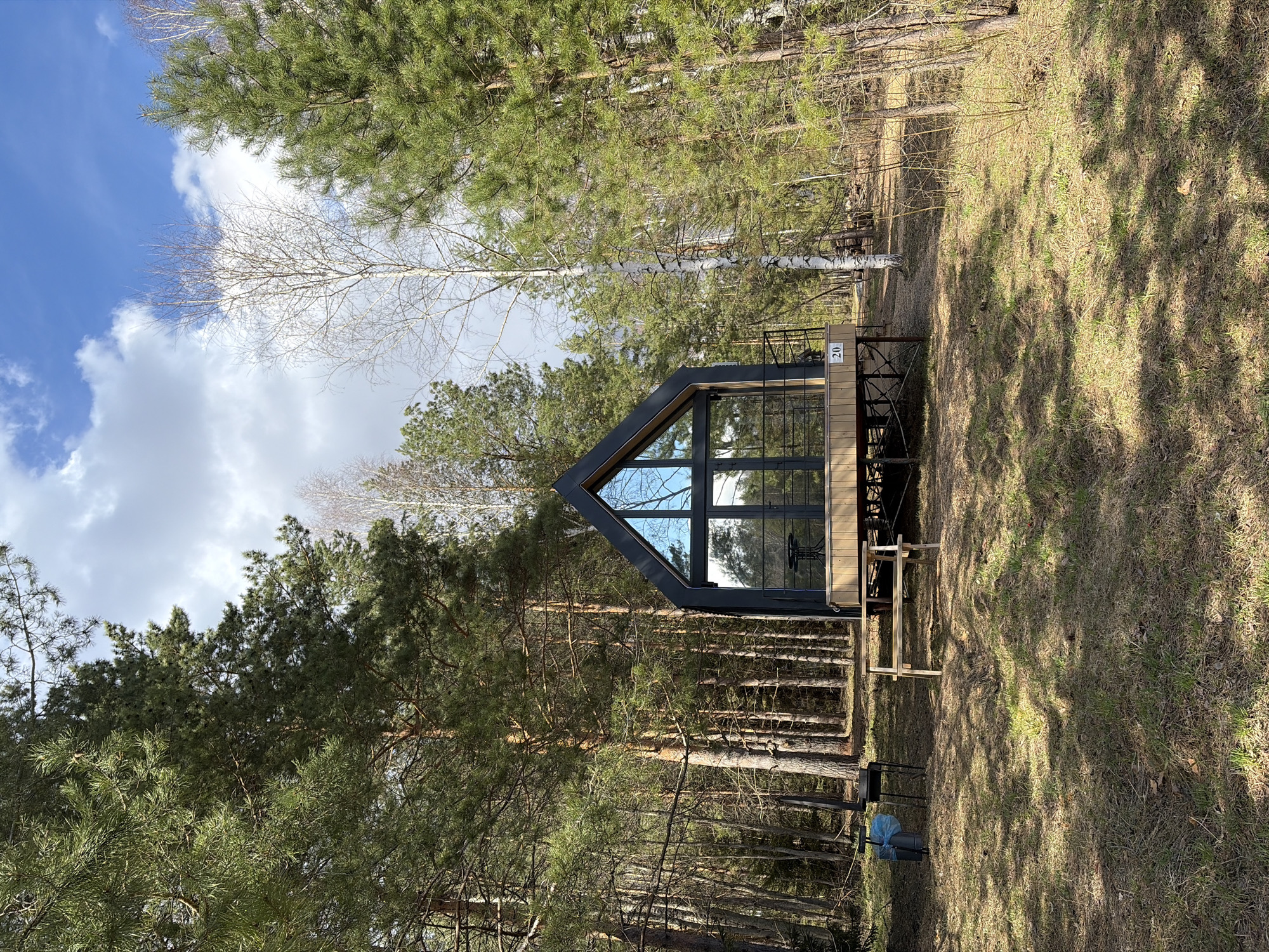 Modern A-frame cabin and forest path documented in Мишкино