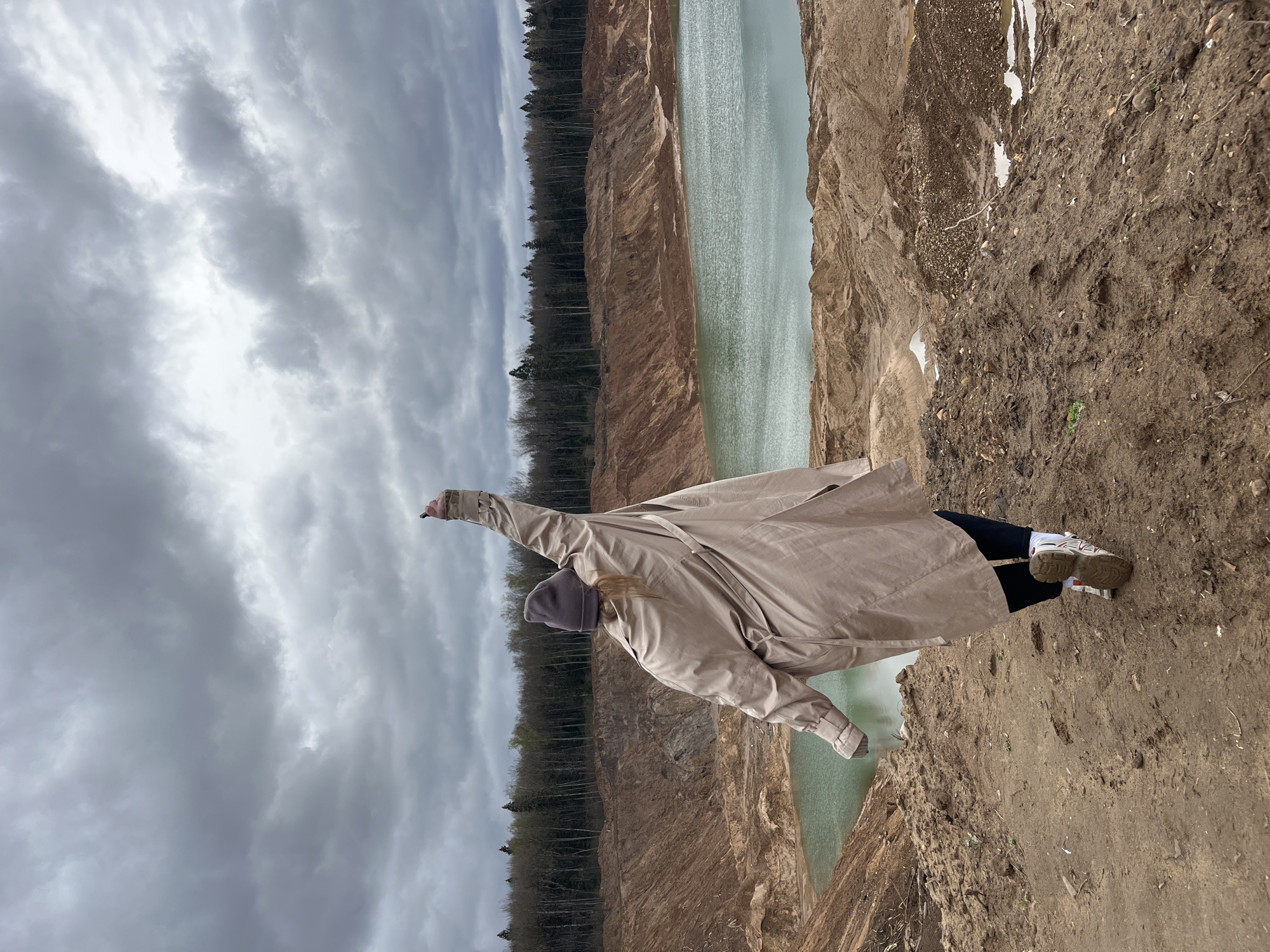 Woman photographs herself at Blue Lakes quarry in Russia