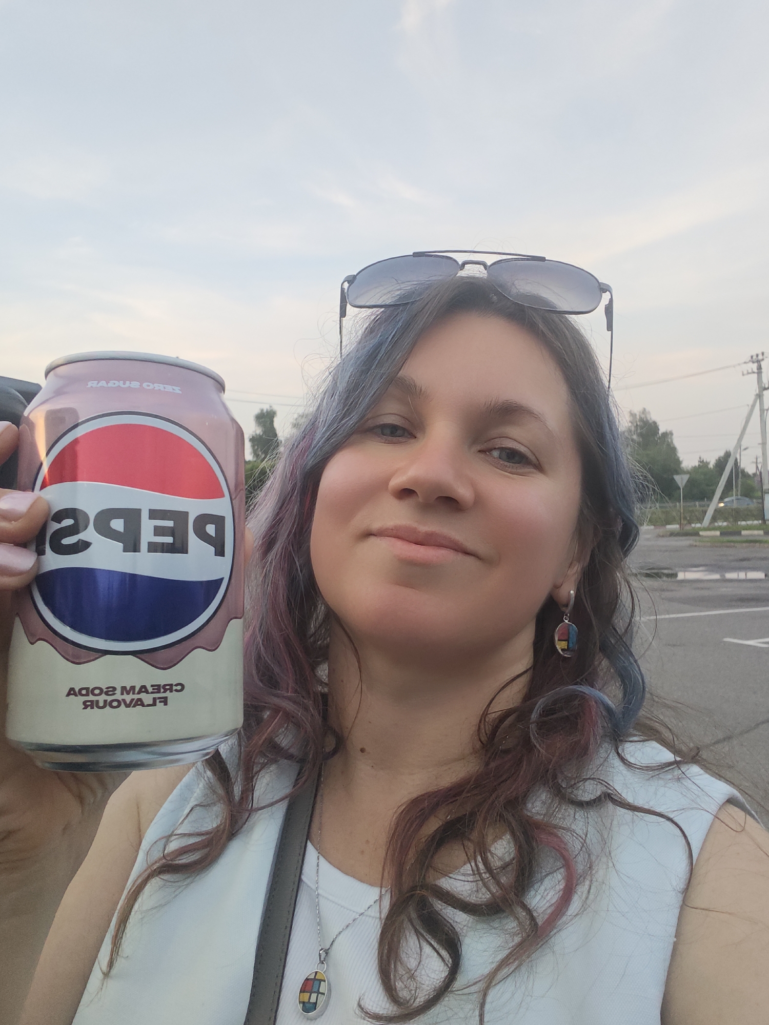 Woman poses with Pepsi cream soda in Russian village