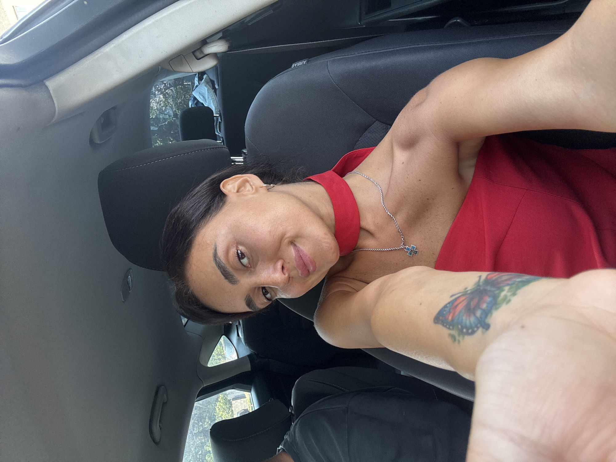 Two people inside a car in Tbilisi, brief July moment.