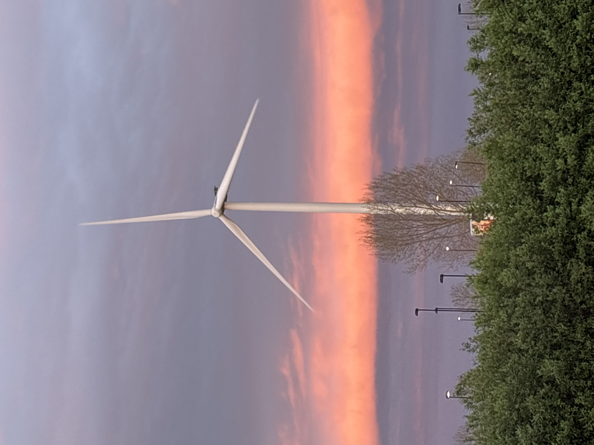 Windmill silhouetted against vibrant sunset in Bruchem, Netherlands