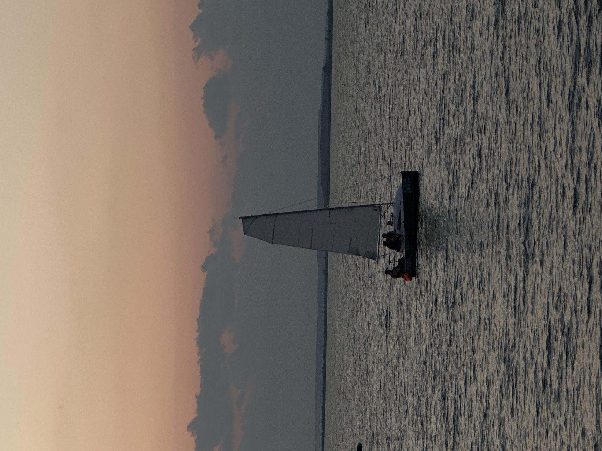 Sailboat on calm Kazakh waters at dusk