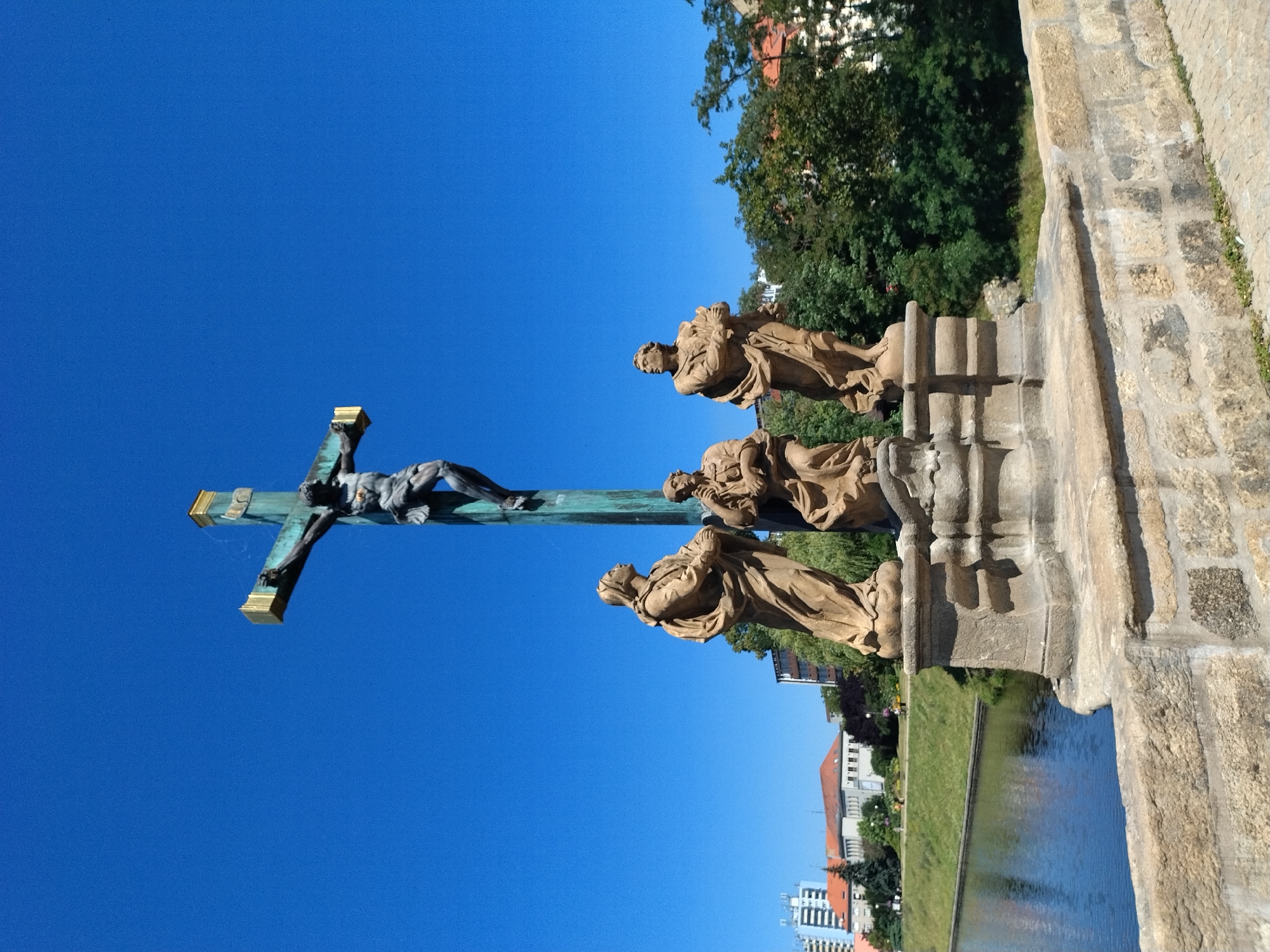 Písek's historic Stone Bridge and baroque sculptures on a sunny morning
