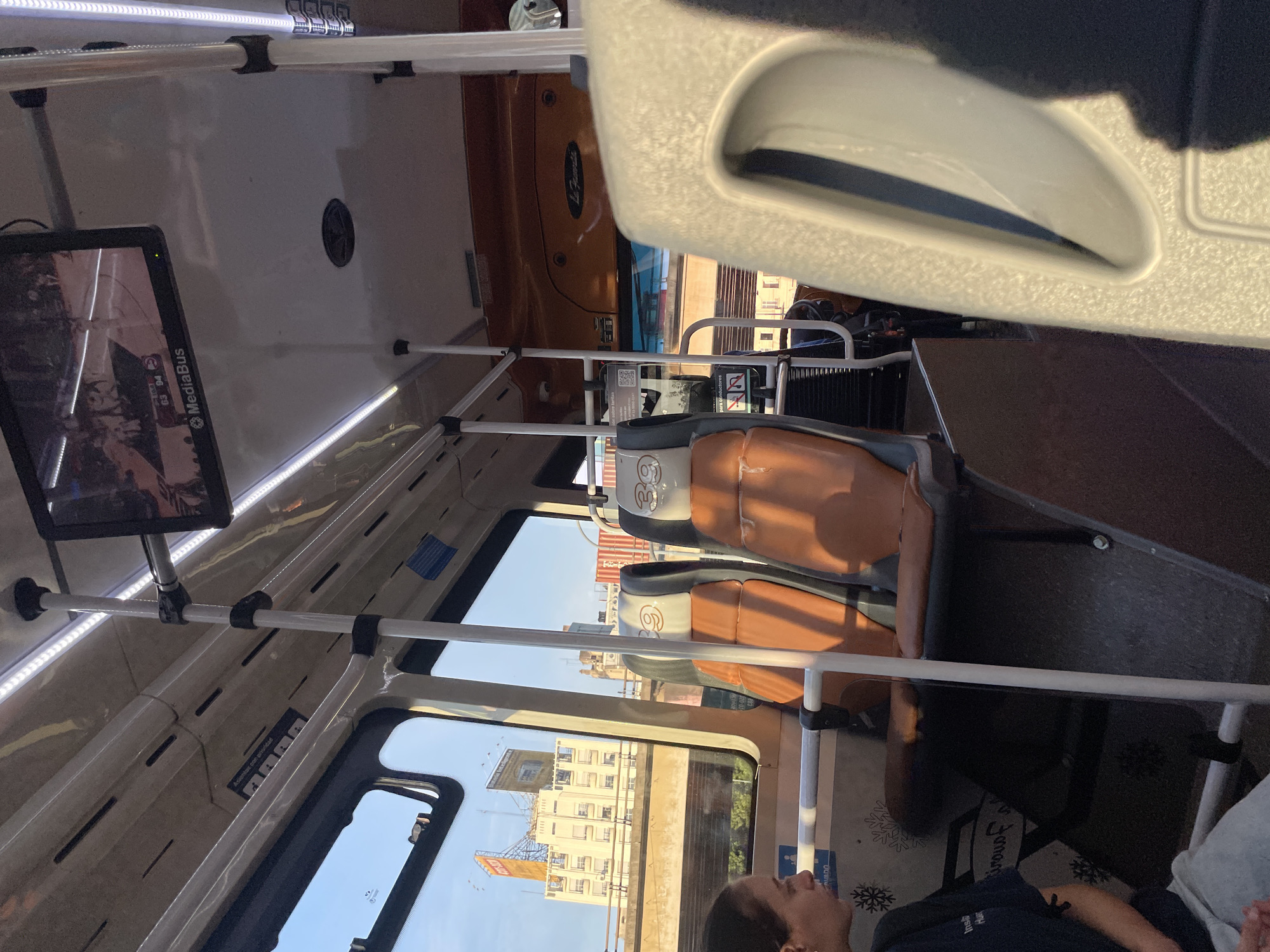 Bus passenger observes Buenos Aires cityscape through window