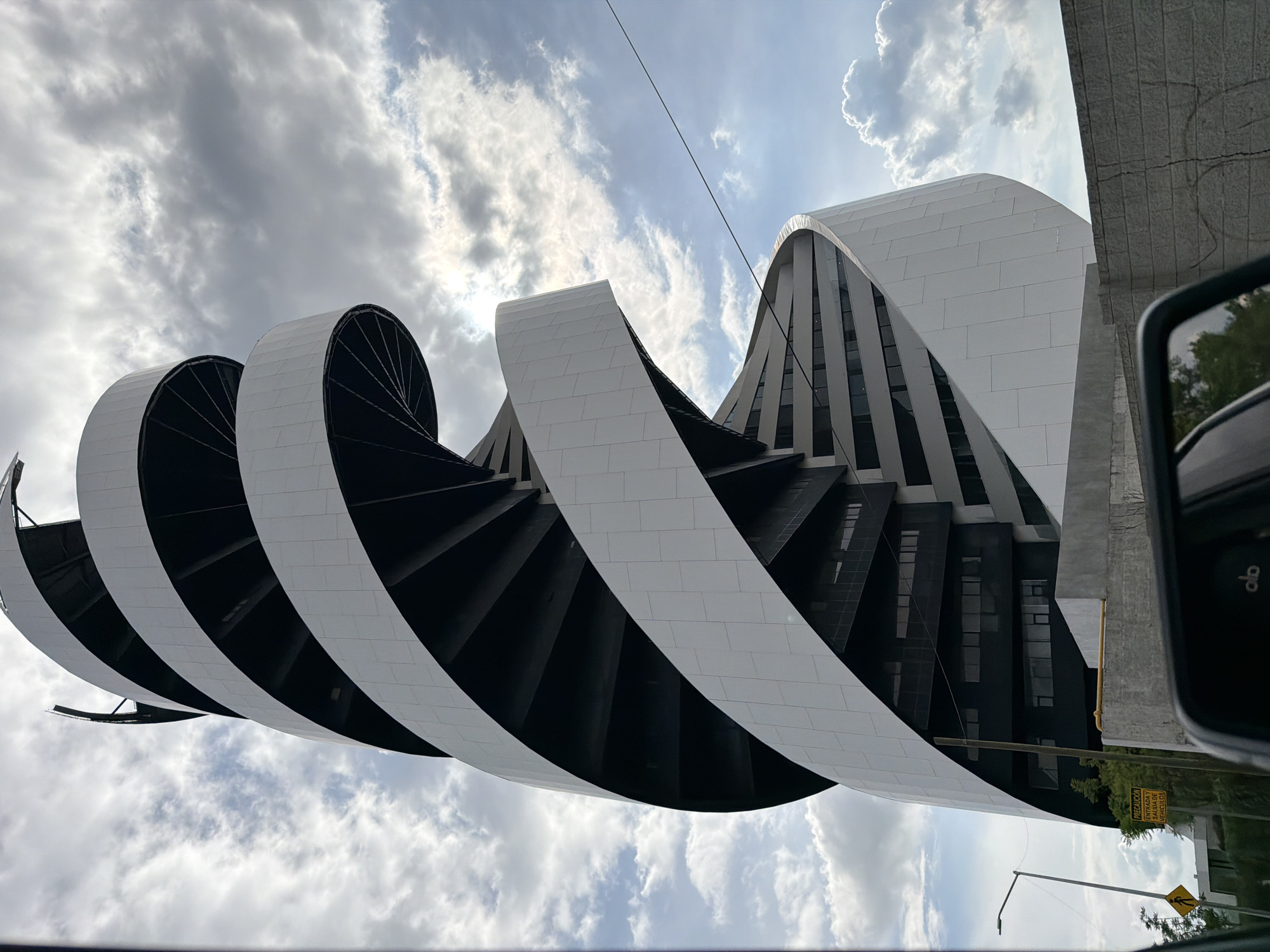 Modern spiral building observed from vehicle in Tlaxcalancingo, Mexico