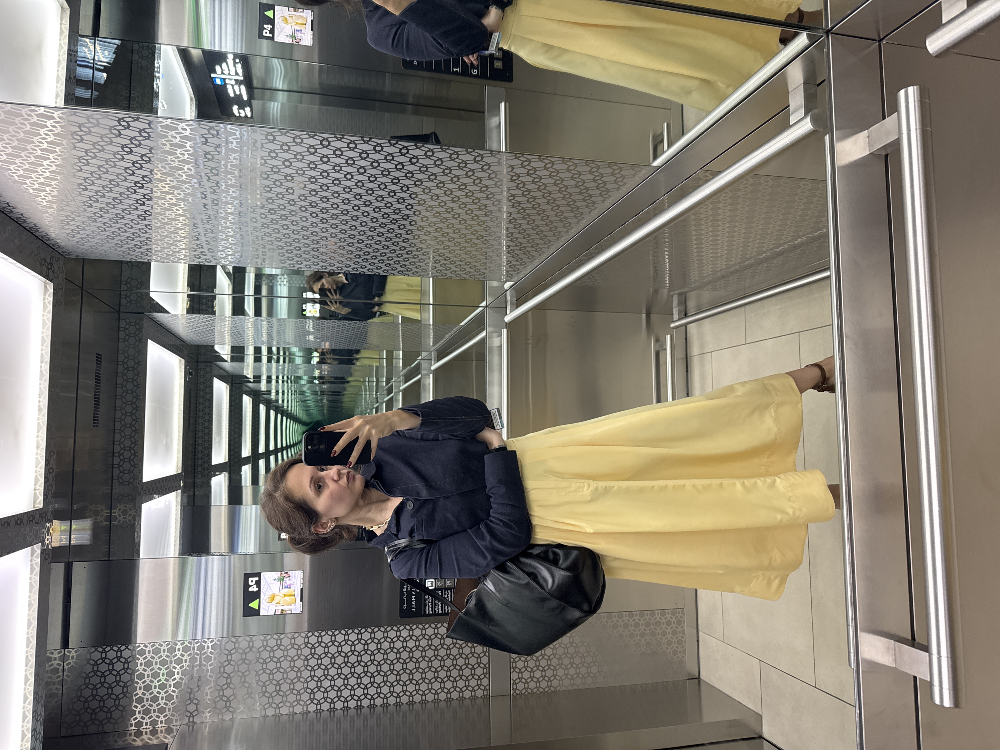 Woman takes selfie in mirrored Dubai elevator