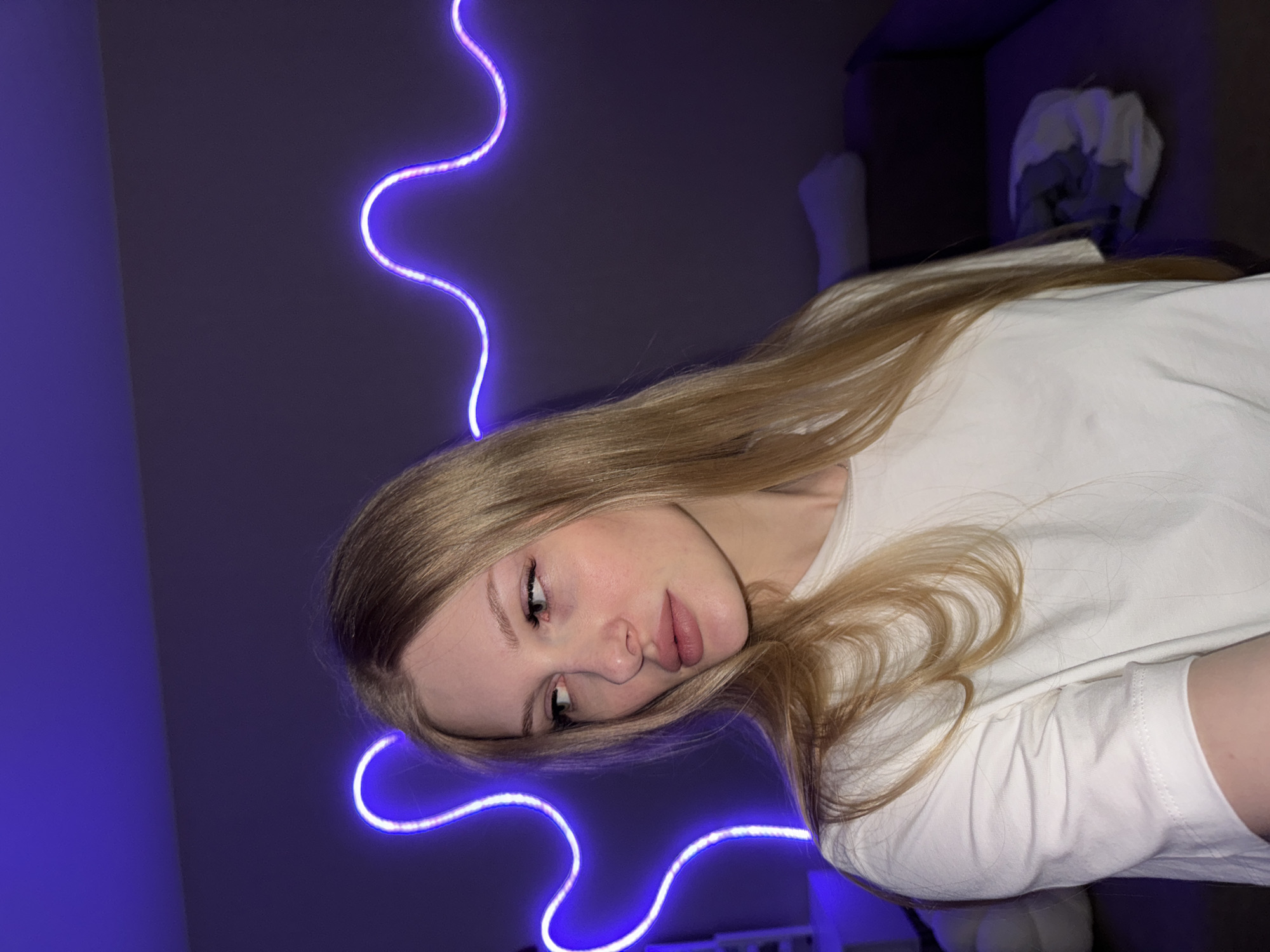 Selfie session in a Perm room with purple neon lighting