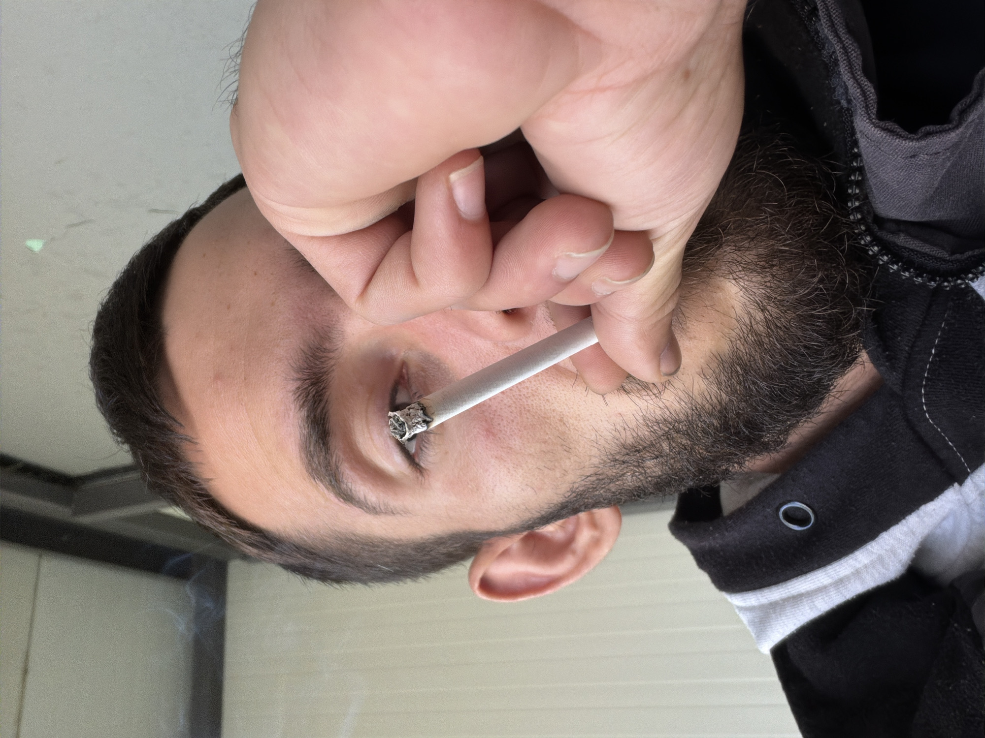 Man photographed smoking indoors in Bulgarian village morning