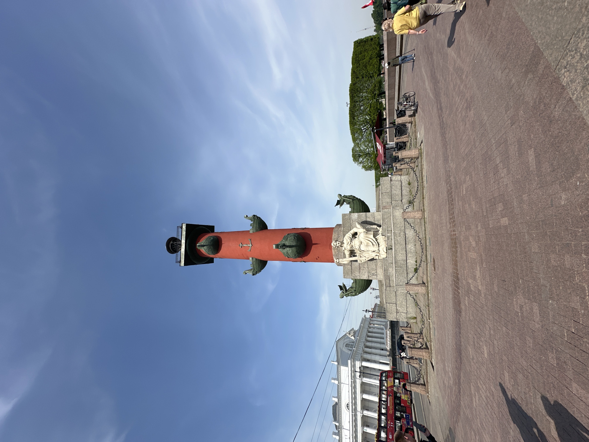 Tourists gather at Saint Petersburg's Rostral Columns on sunny morning