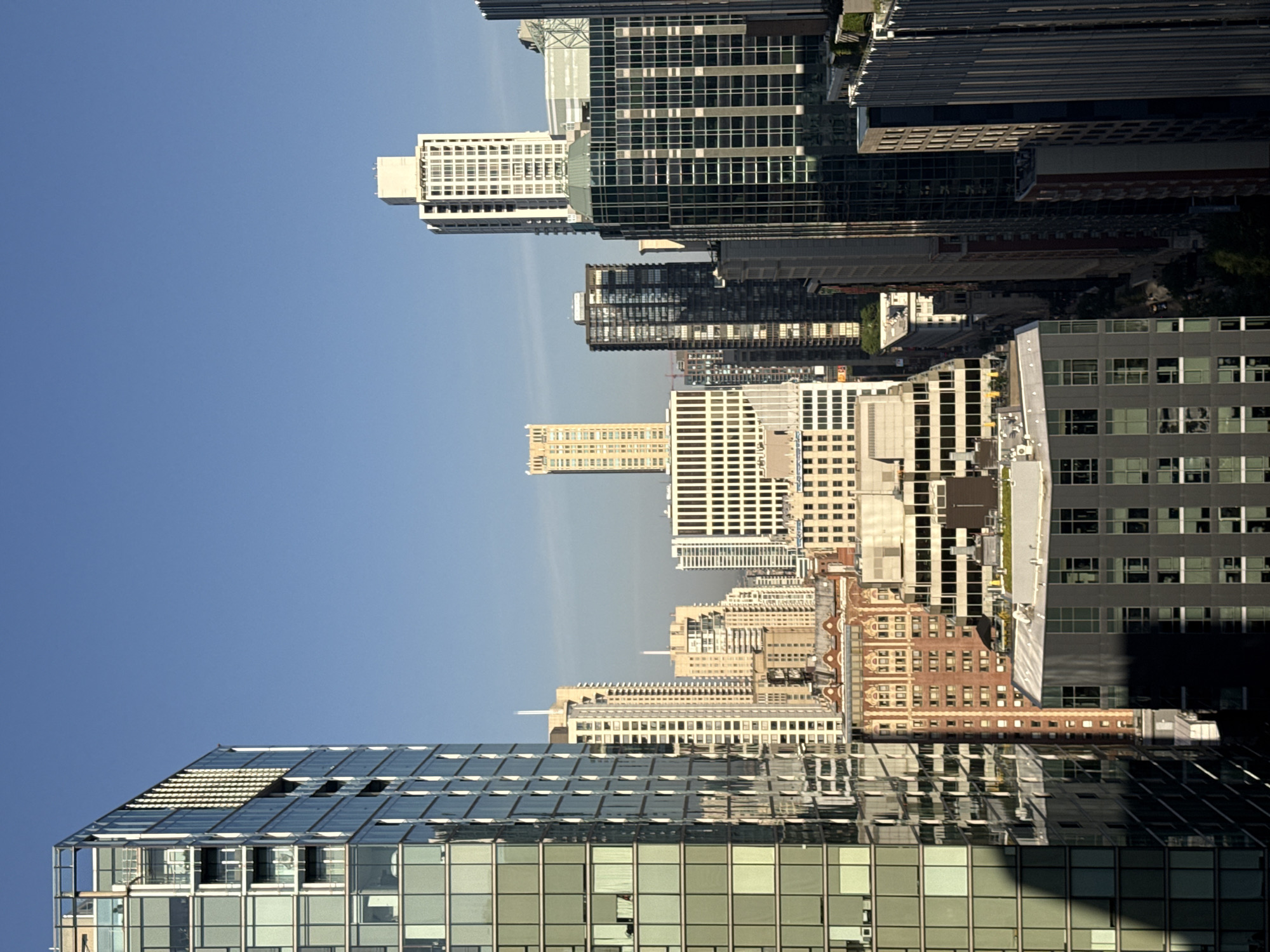 Helicopter over Chicago's dense downtown skyline, mid-summer afternoon