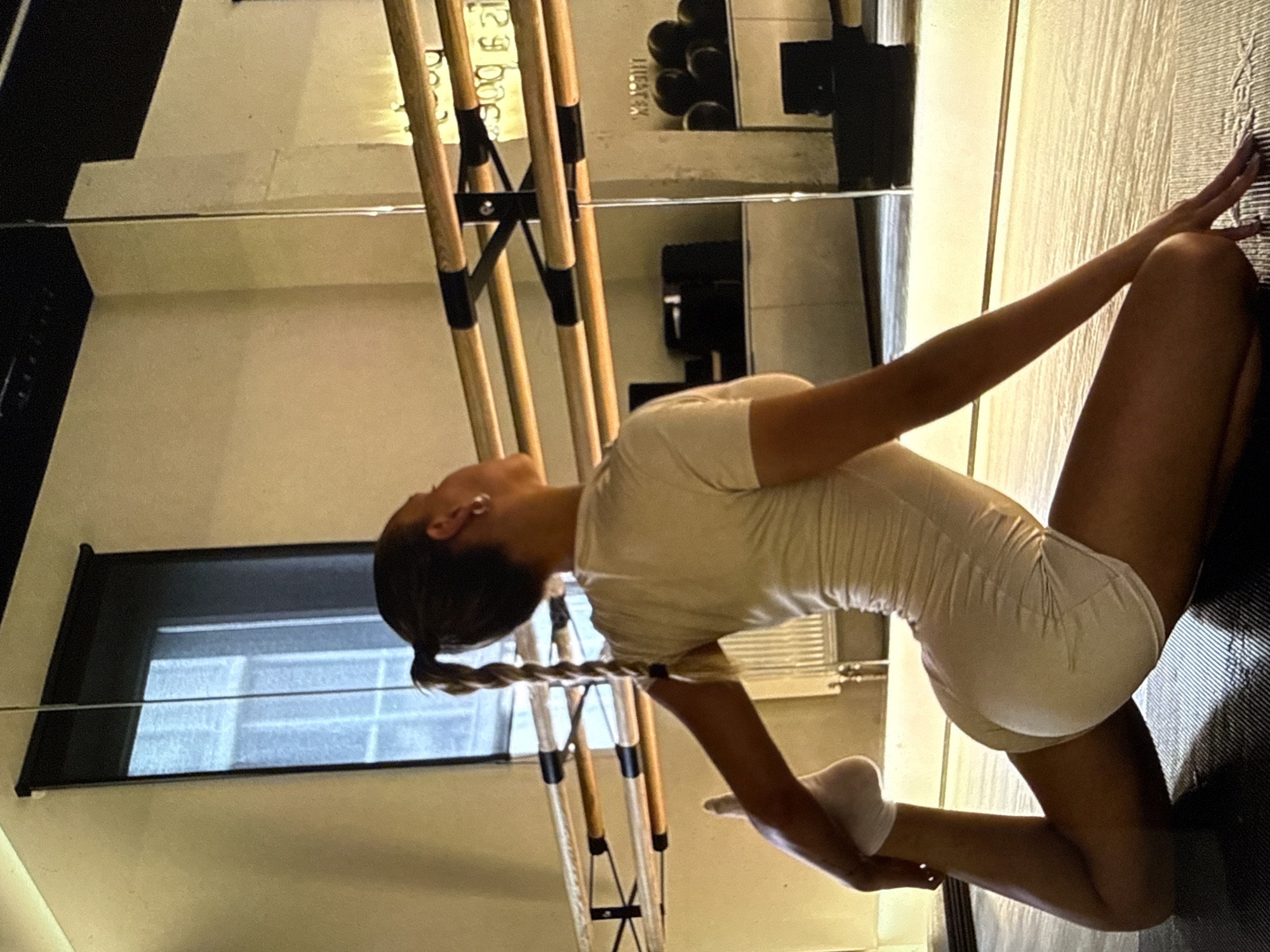 Woman performs stretching routine on black surface in Sofia
