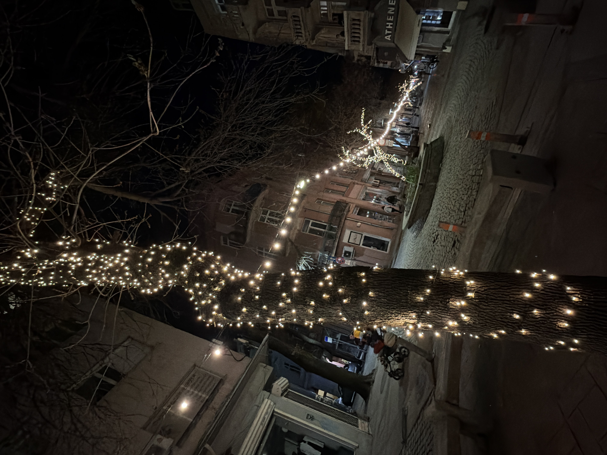 Urban plaza illuminated with string lights captured at night