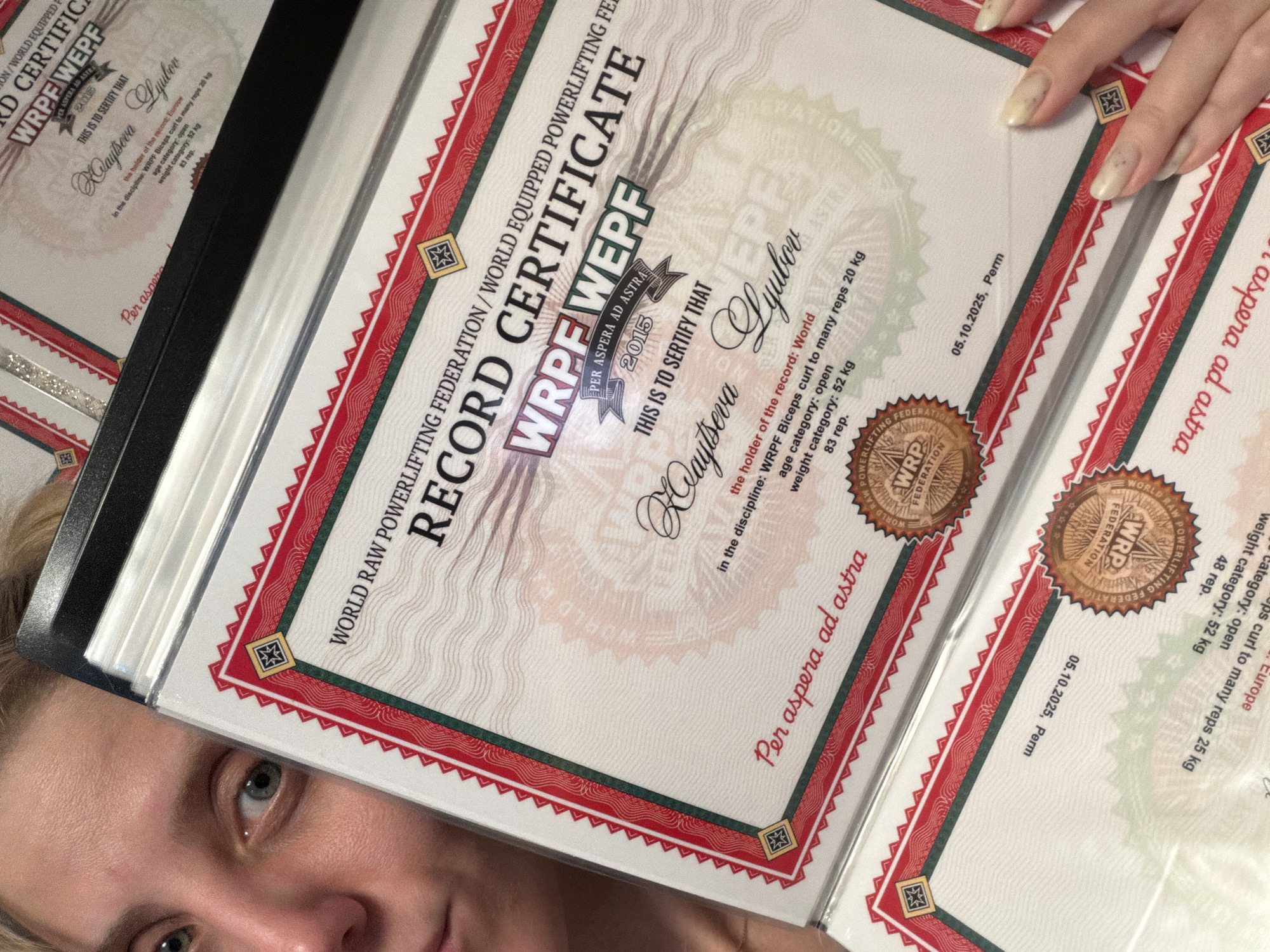 Russian powerlifter documents medals and achievements at home