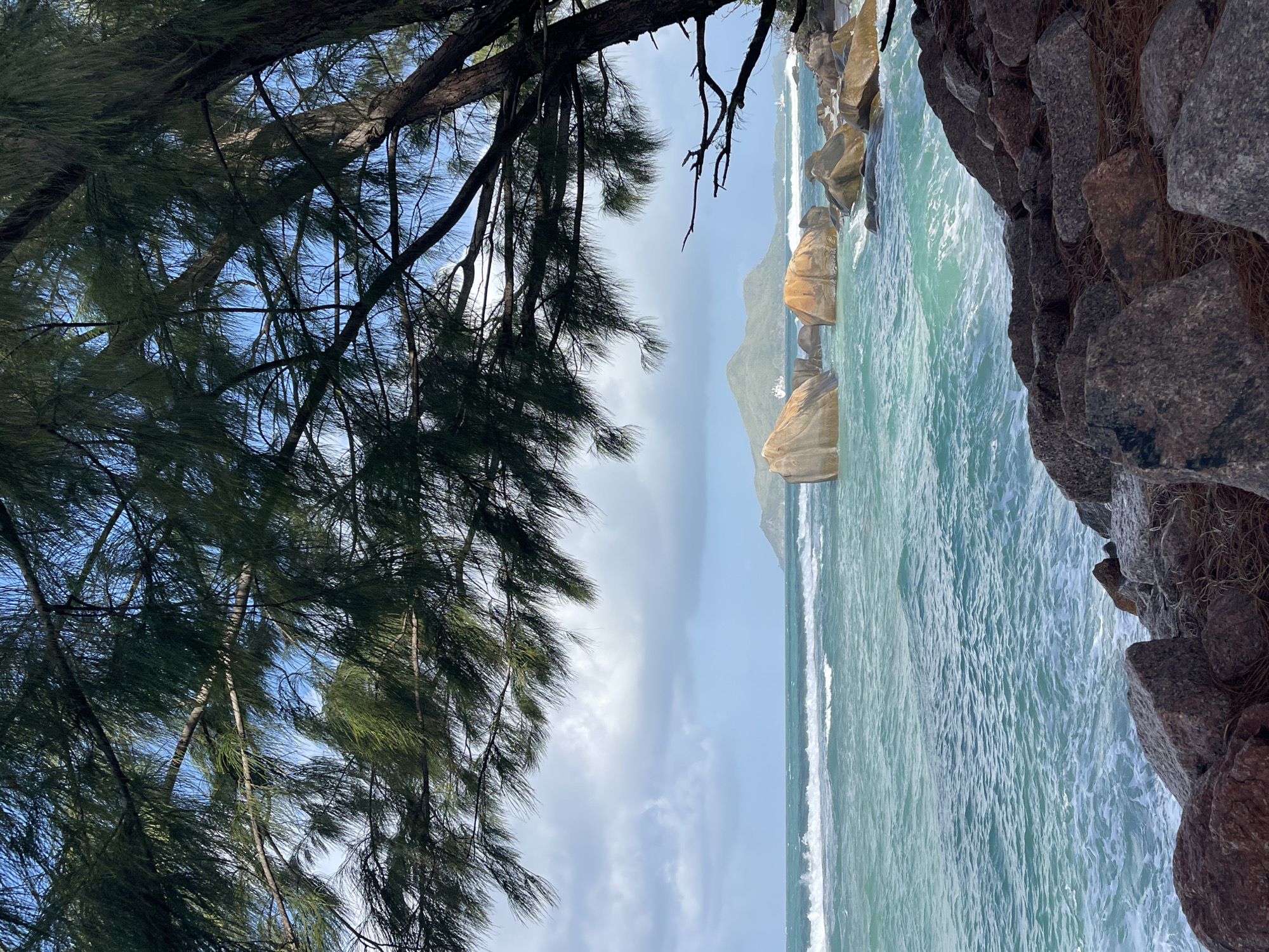 Waves breaking on a boulder-lined Seychelles coast