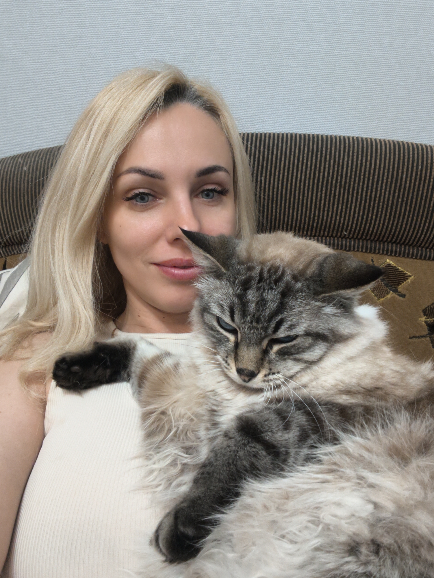 Woman documents quiet afternoon with cats and aquarium in Sevastopol