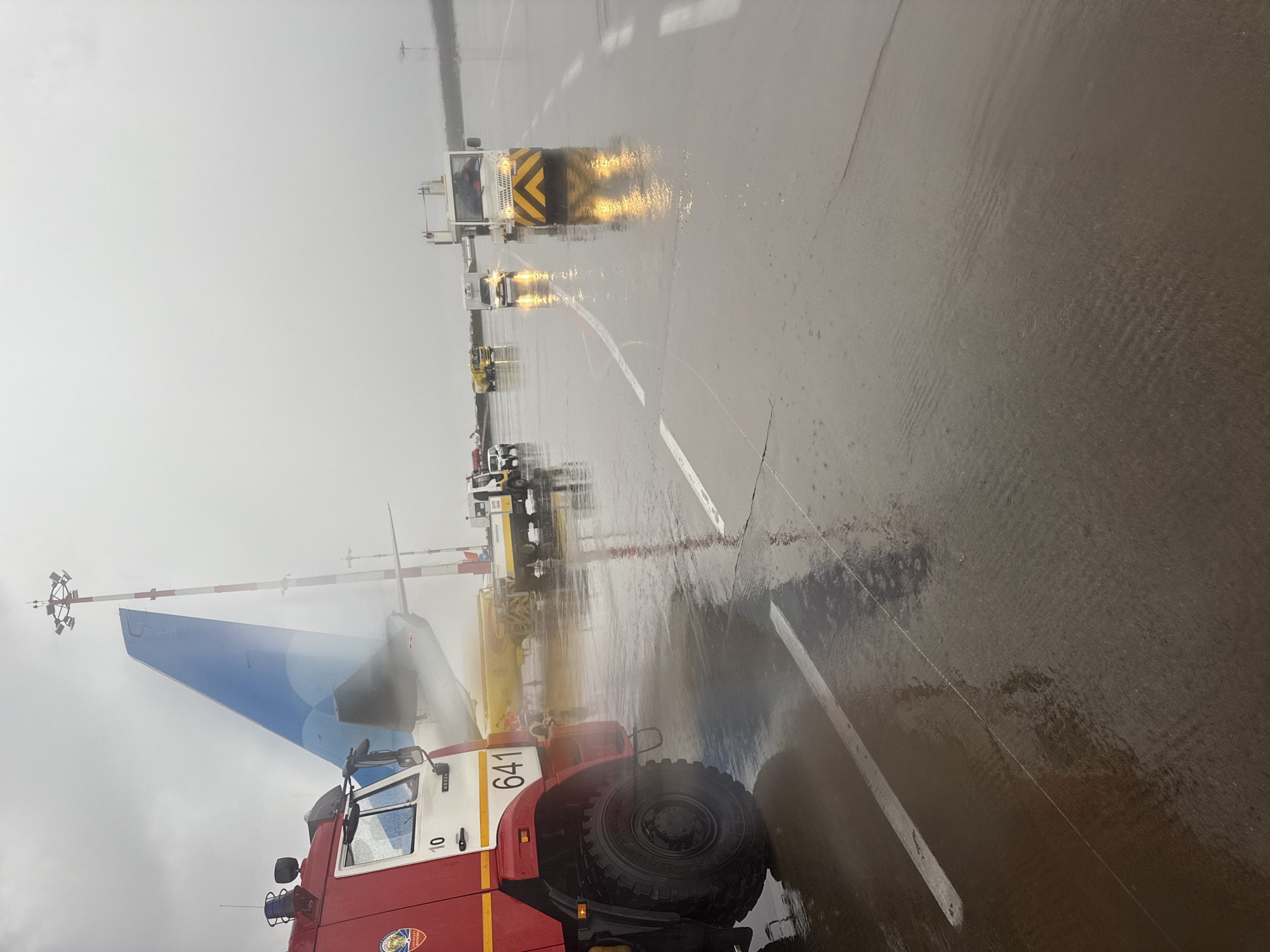 Aircraft receives de-icing treatment at Vnukovo Airport during wet weather