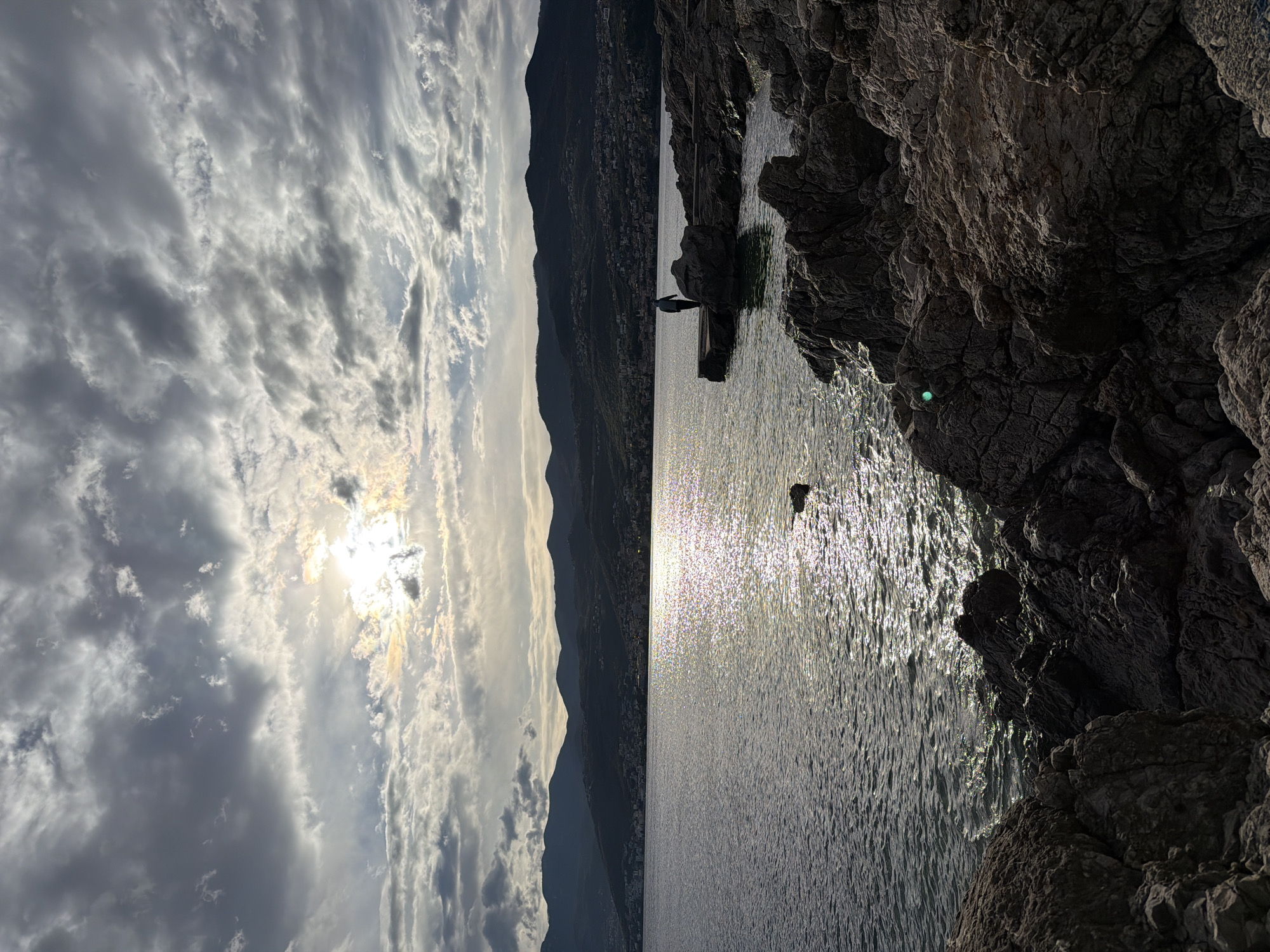 Woman poses on Rijeka waterfront amid coastal scenery