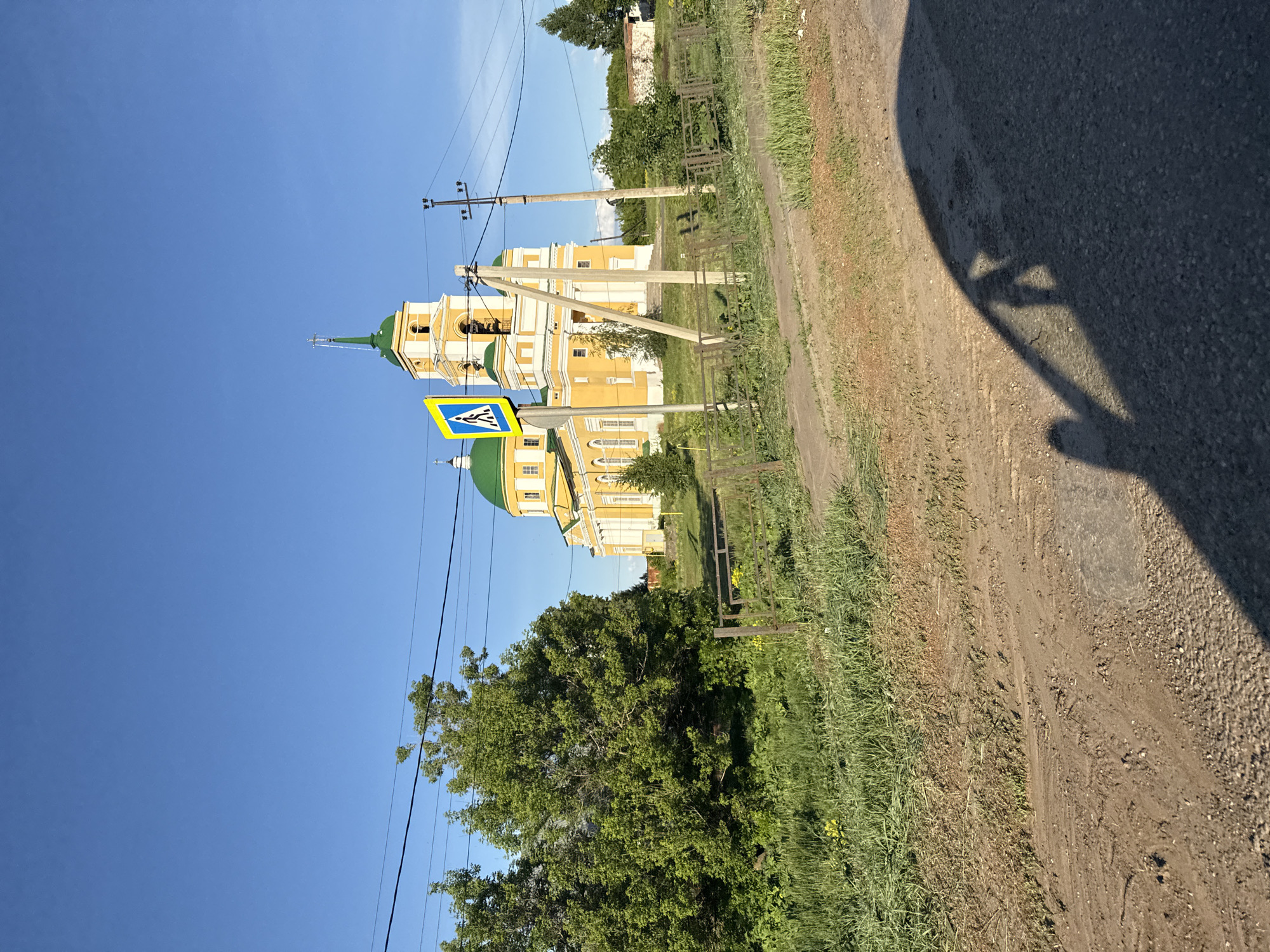 Sunny drive past church in rural Мазунино, Russia