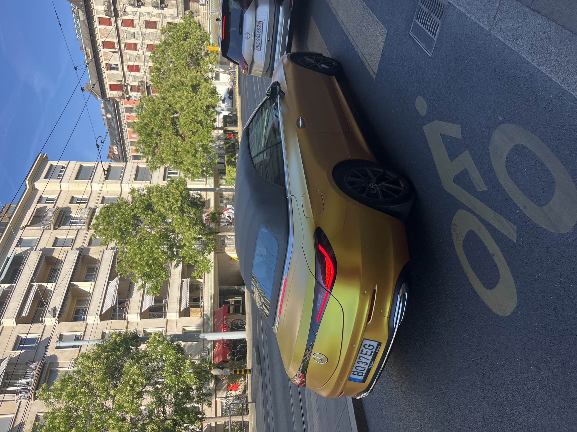 Gold Mercedes EQC convertible parked on a Geneva street