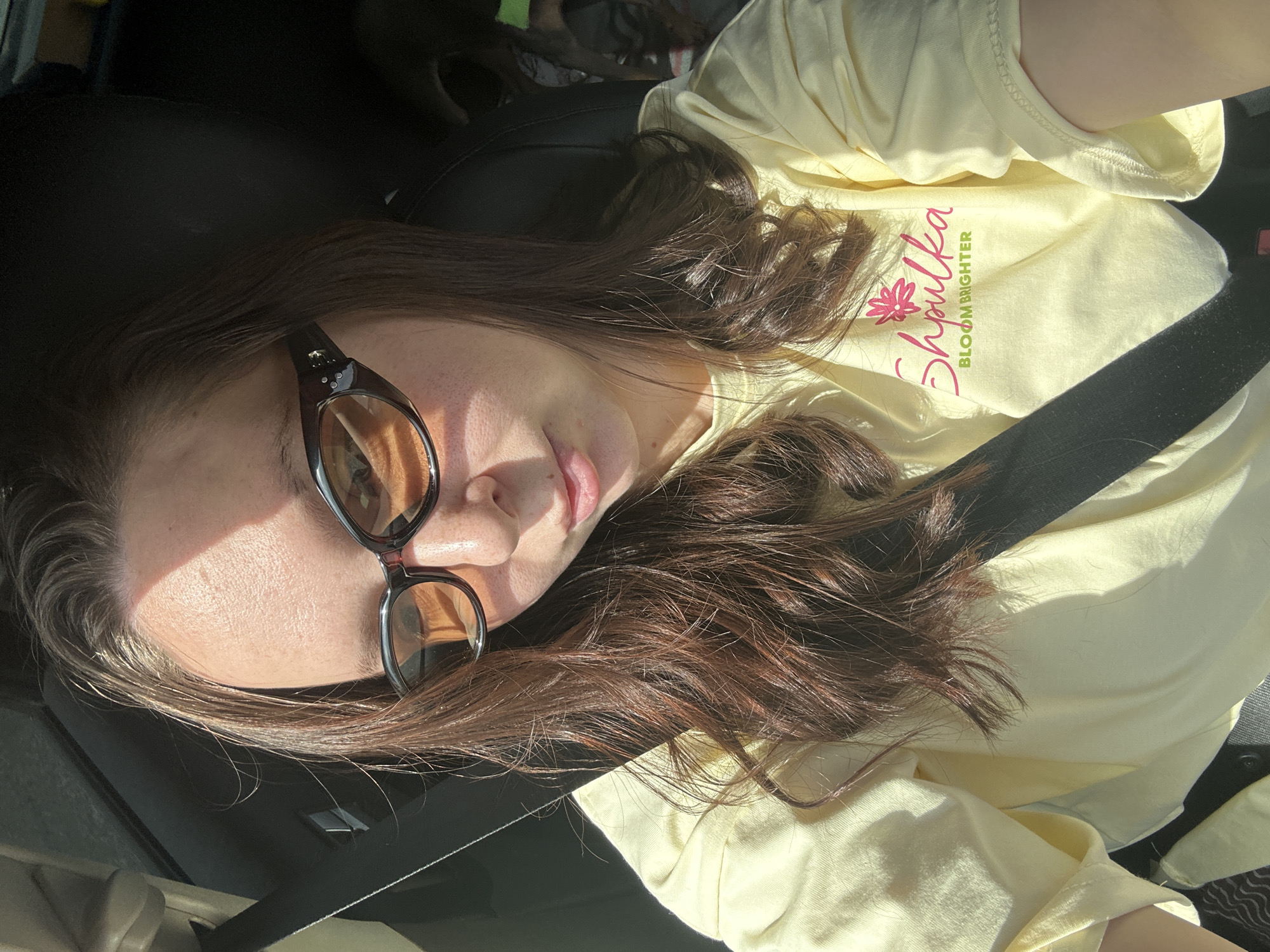 Person in yellow shirt rests in car near Кельчино