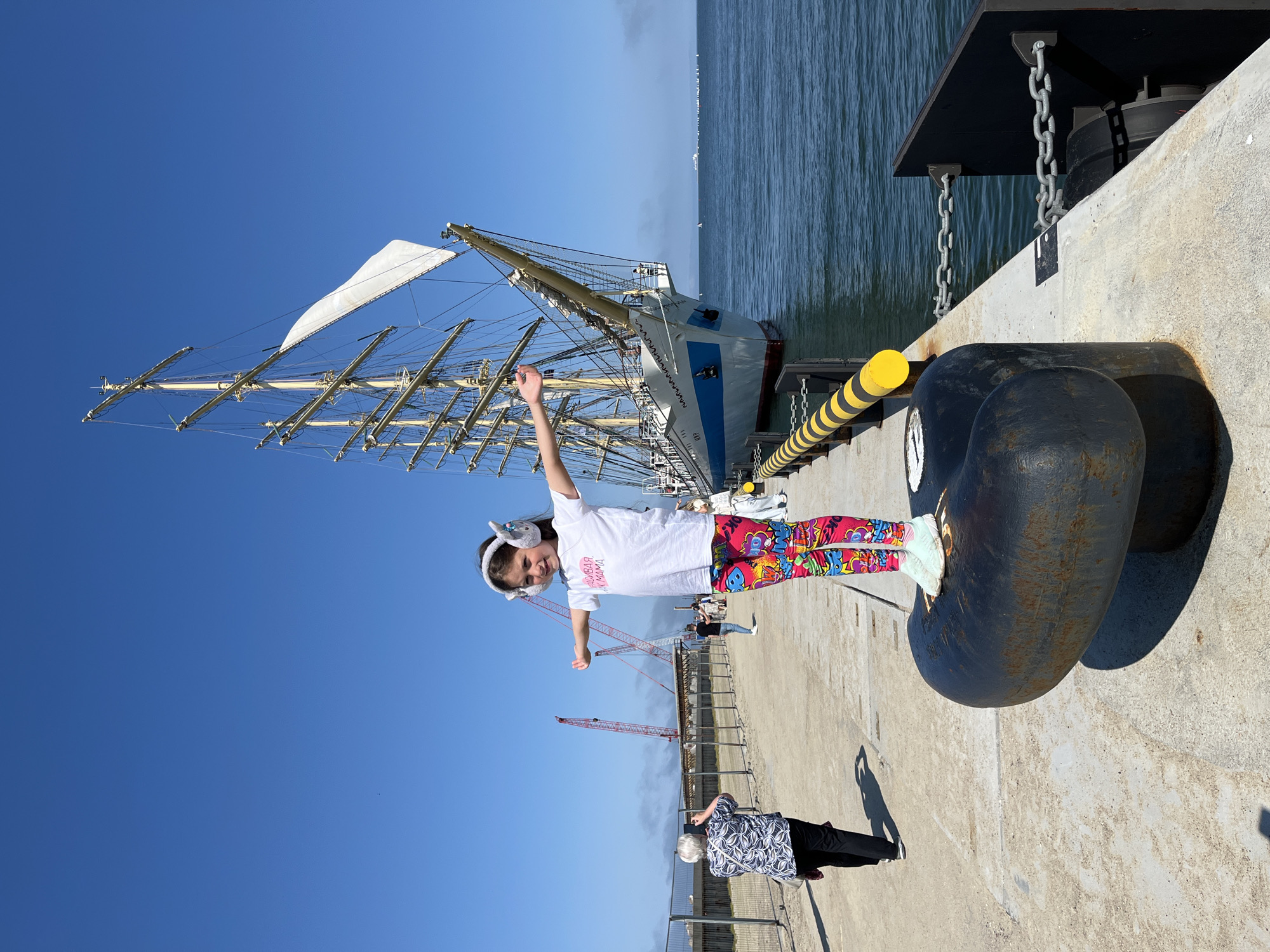 Sunny afternoon at Pionersky's waterfront with a tall ship