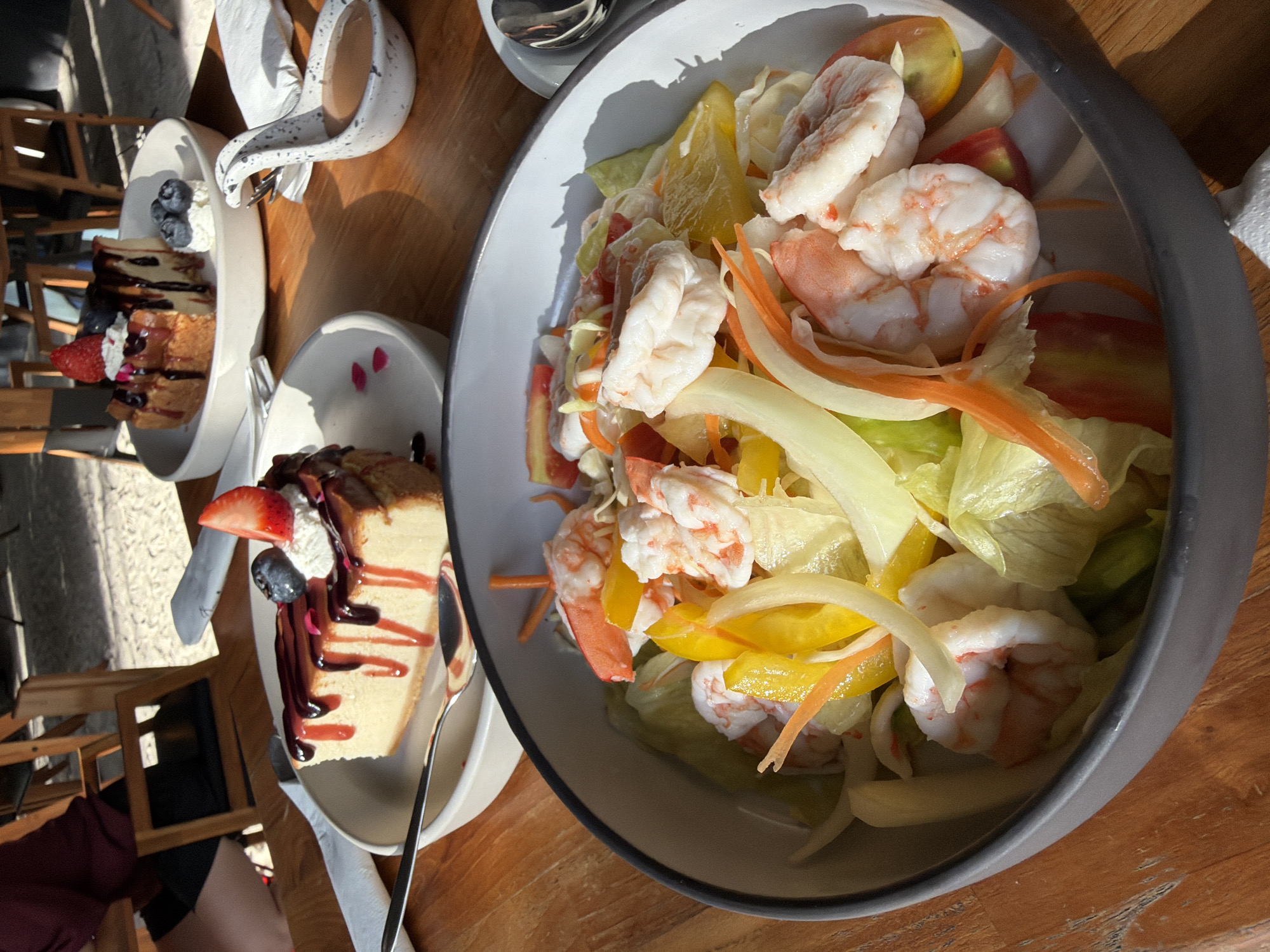 Shrimp salad and cheesecake at a sunny Ko Samui café