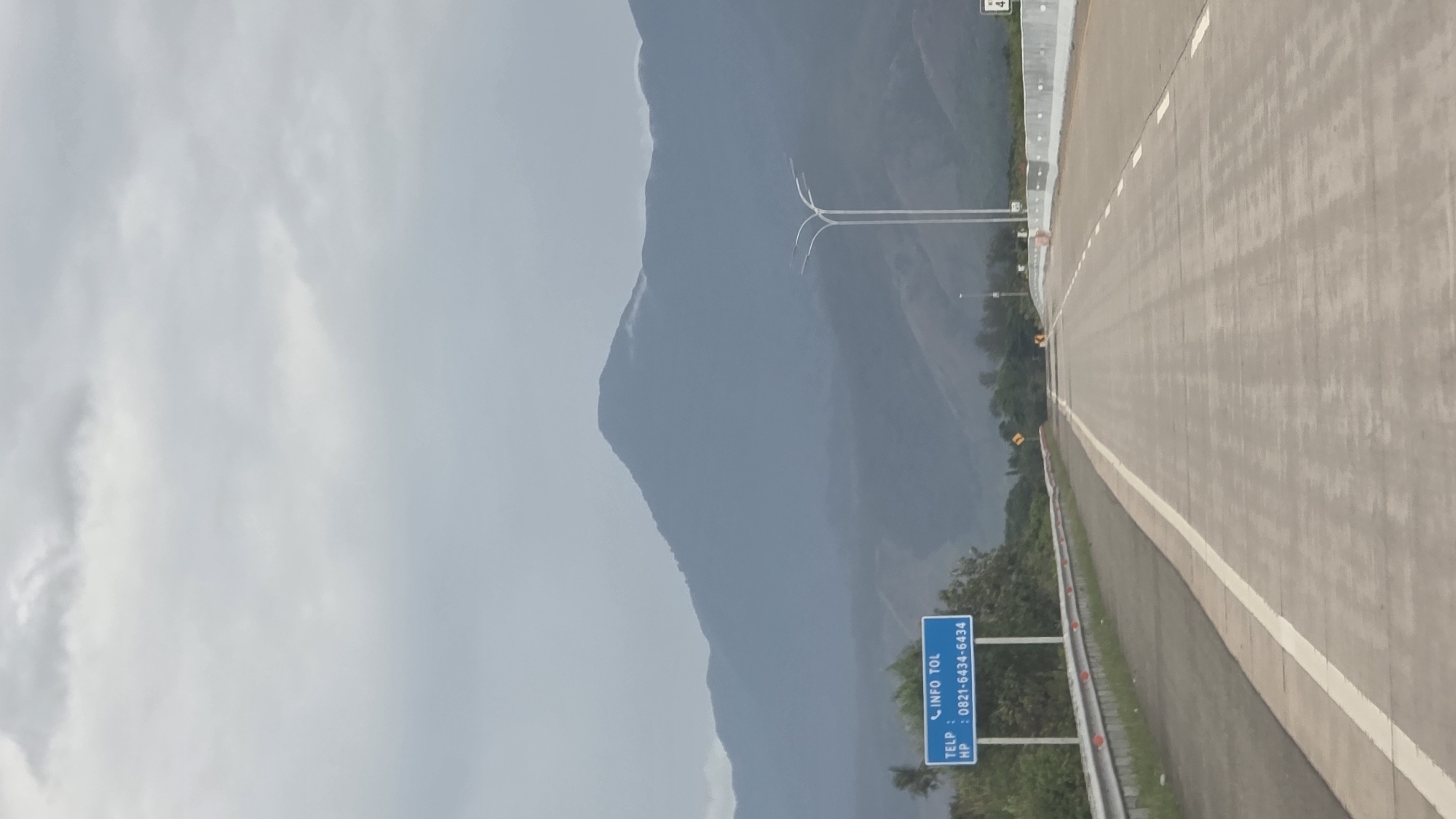 Highway scene documented near mountains in Baksukon, Indonesia