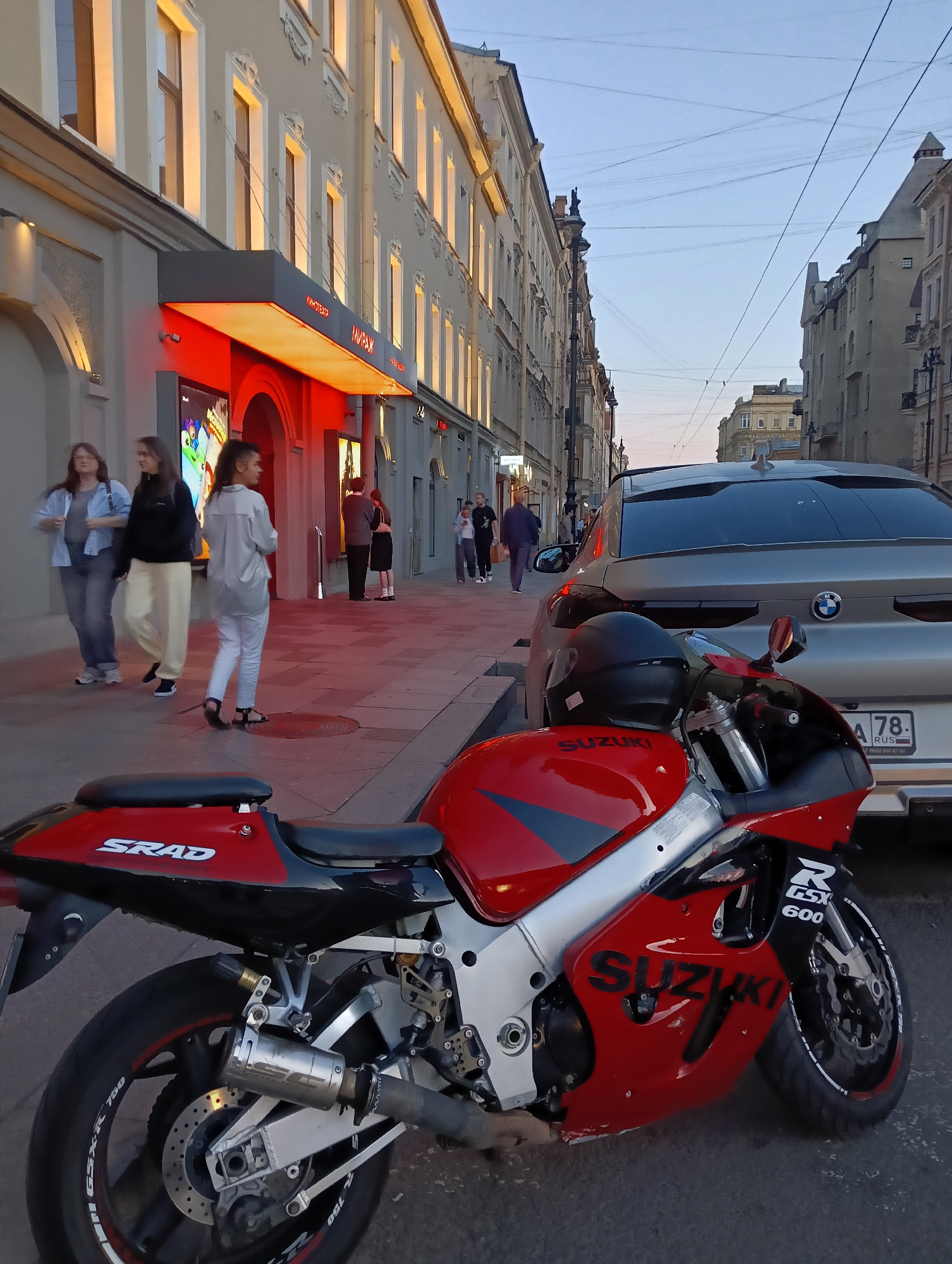 Evening stop in Saint Petersburg, Suzuki parked outside cinema and cafe