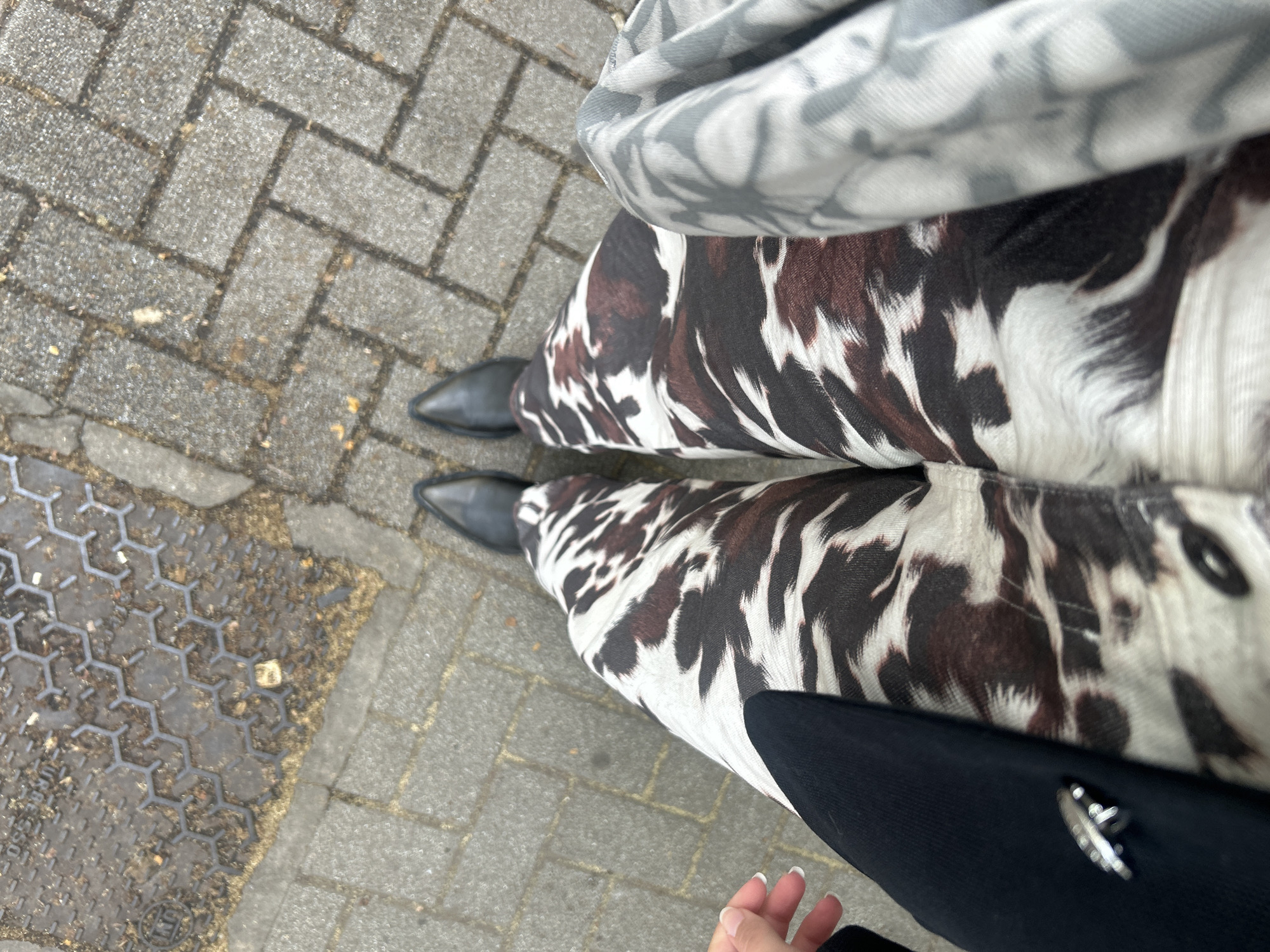 Woman in cow-print pants spotted at Milan bus stop