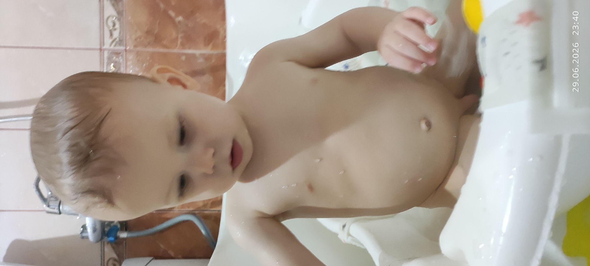 Baby's bath time, multiple angles in a tiled bathroom