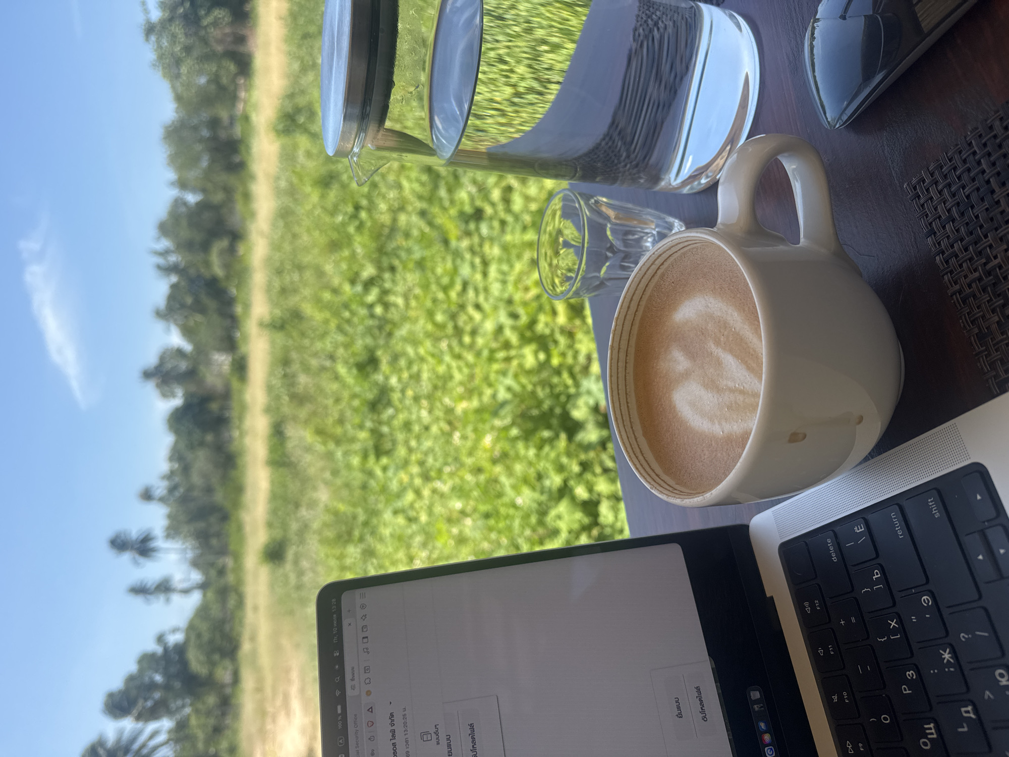 Laptop and coffee on a woven mat in Ko Samui